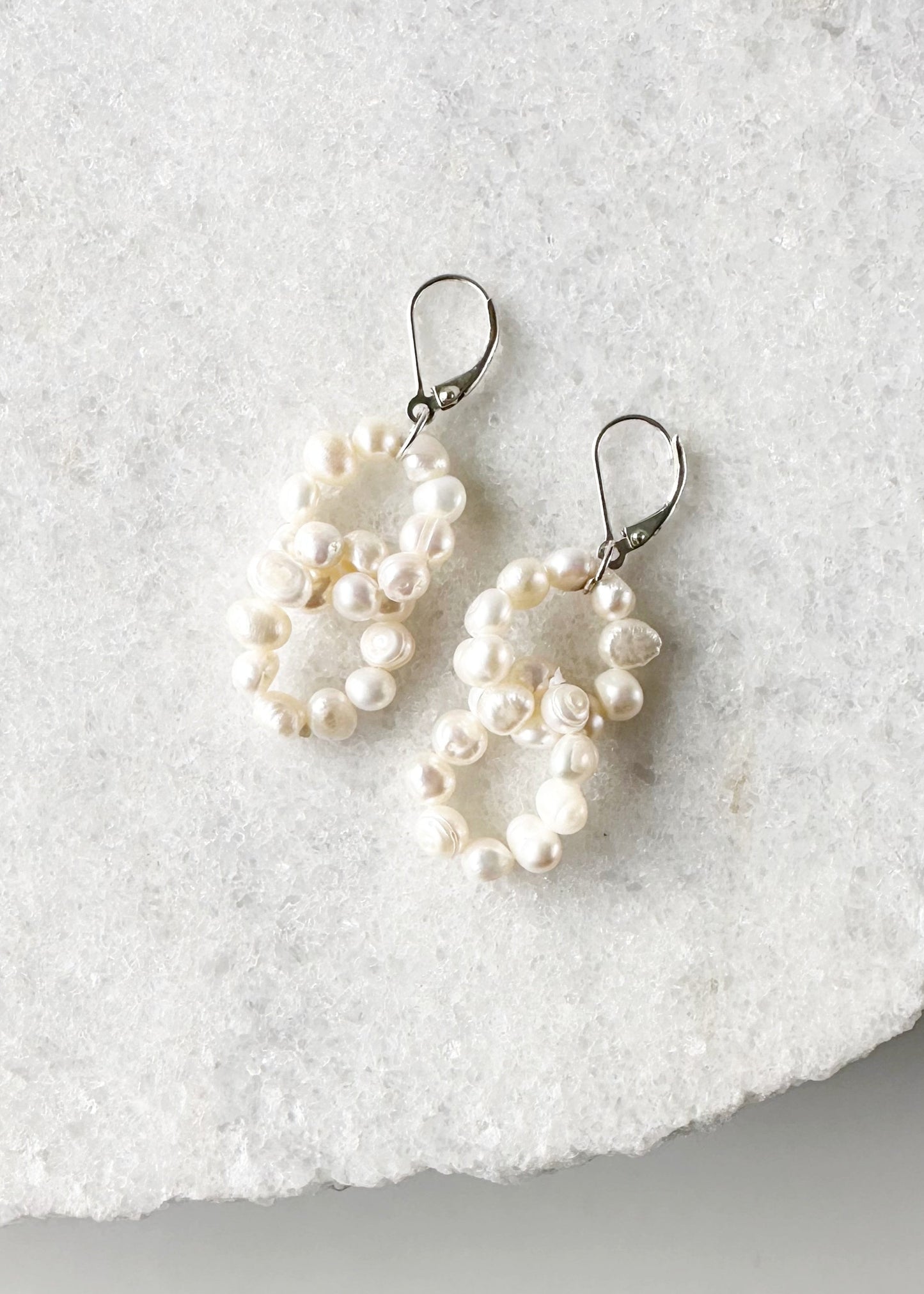 Two Linked Rings of Tiny White Baroque Freshwater Pearls highlight these Earrings with Sterling Silver Lever Backs.