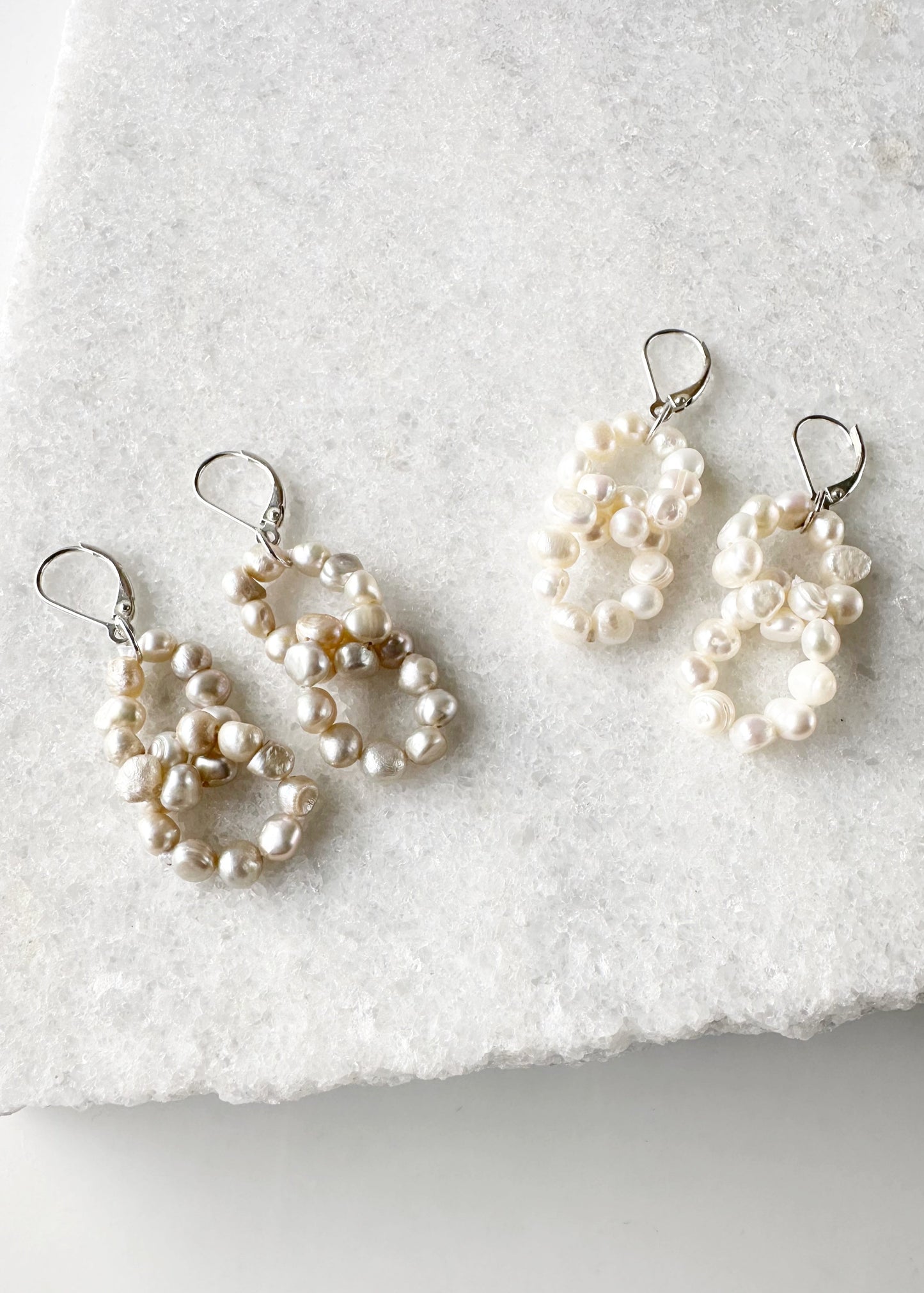 Two Linked Rings of Tiny White or Champagne Baroque Freshwater Pearls highlight these Earrings with Sterling Silver Lever Backs.