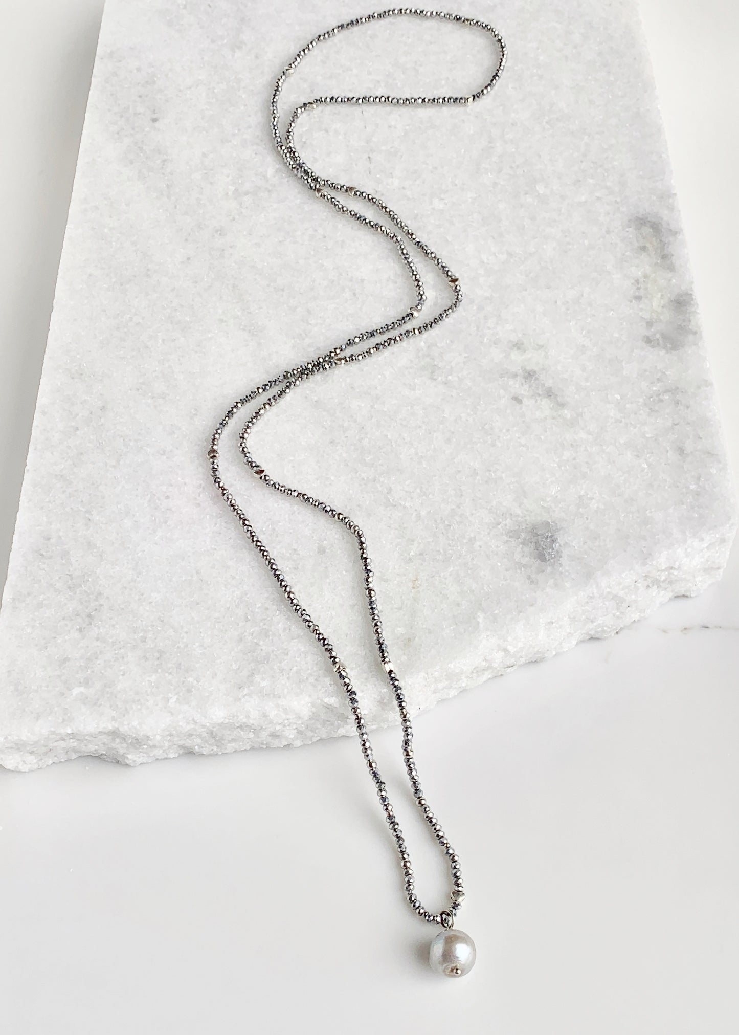 A White Freshwater Pearl Drop falls from this 21” Necklace of Delicate 2mm Silver Crystals and Silver Beads with No Clasp.  Great for Layering with Other Favorites.