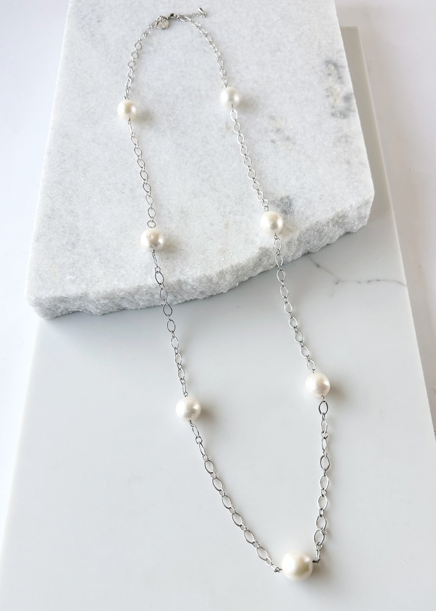 Seven Large White Edison Freshwater Pearls sit on a 36.5” White Gold-Plated Chain with 1.5” Extender for this Necklace with Lobster Claw Clasp.