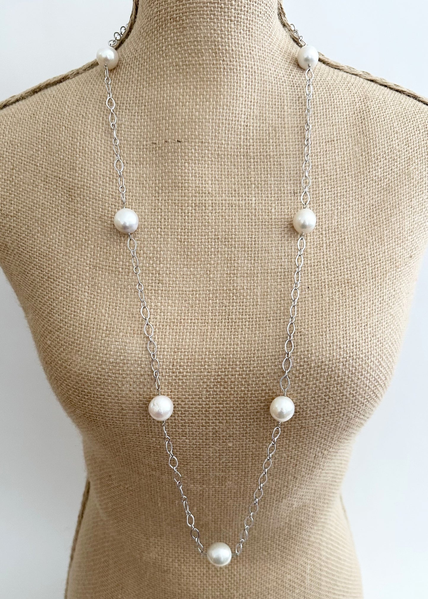 Seven Large White Edison Freshwater Pearls sit on a 36.5” White Gold-Plated Chain with 1.5” Extender for this Necklace with Lobster Claw Clasp. Shown on Bust