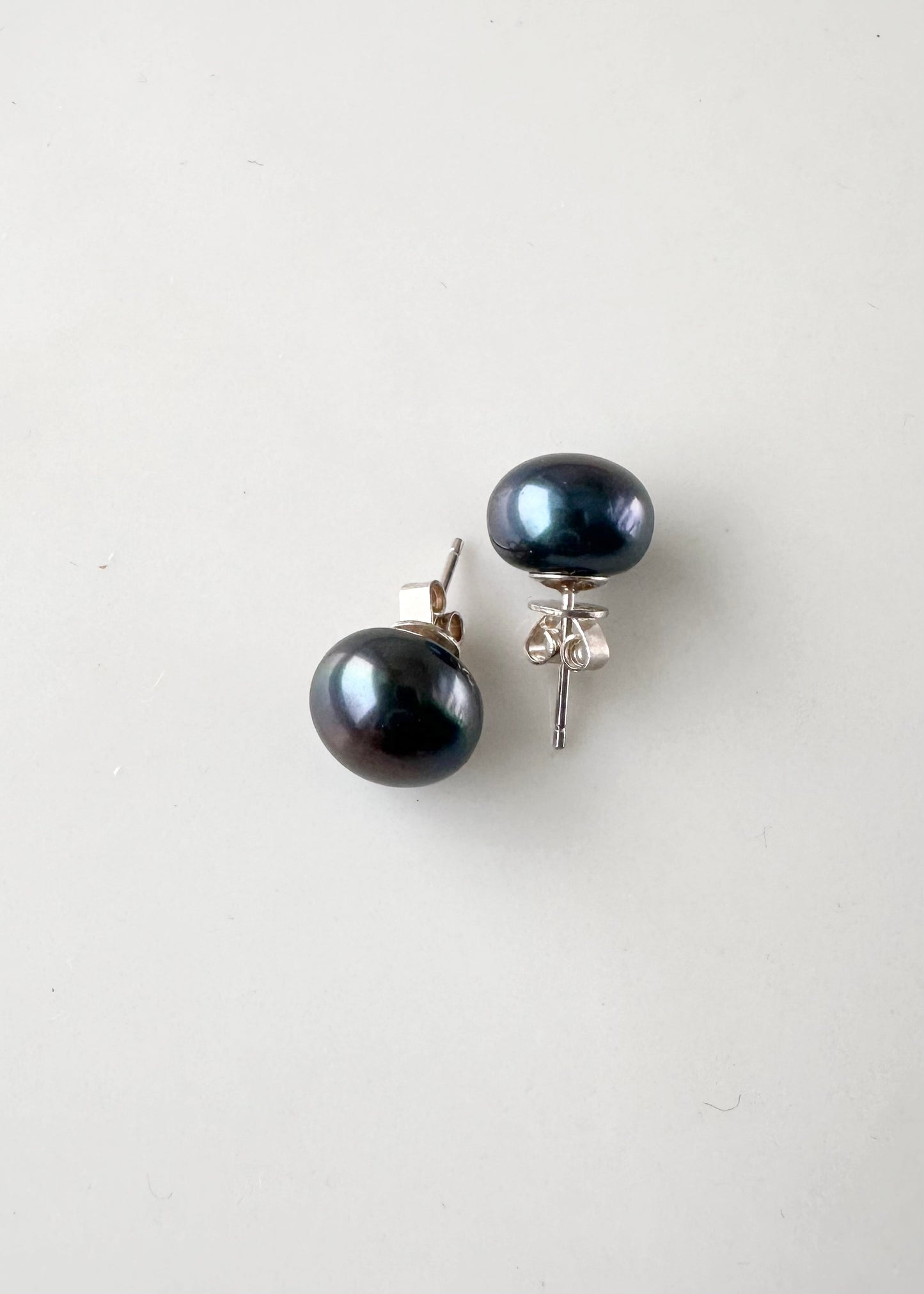 These Pretty Black (Grade A) 10-11mm Freshwater Pearl Stud Earrings are on Sterling Silver Post and Butterfly.  A Fan Favorite!