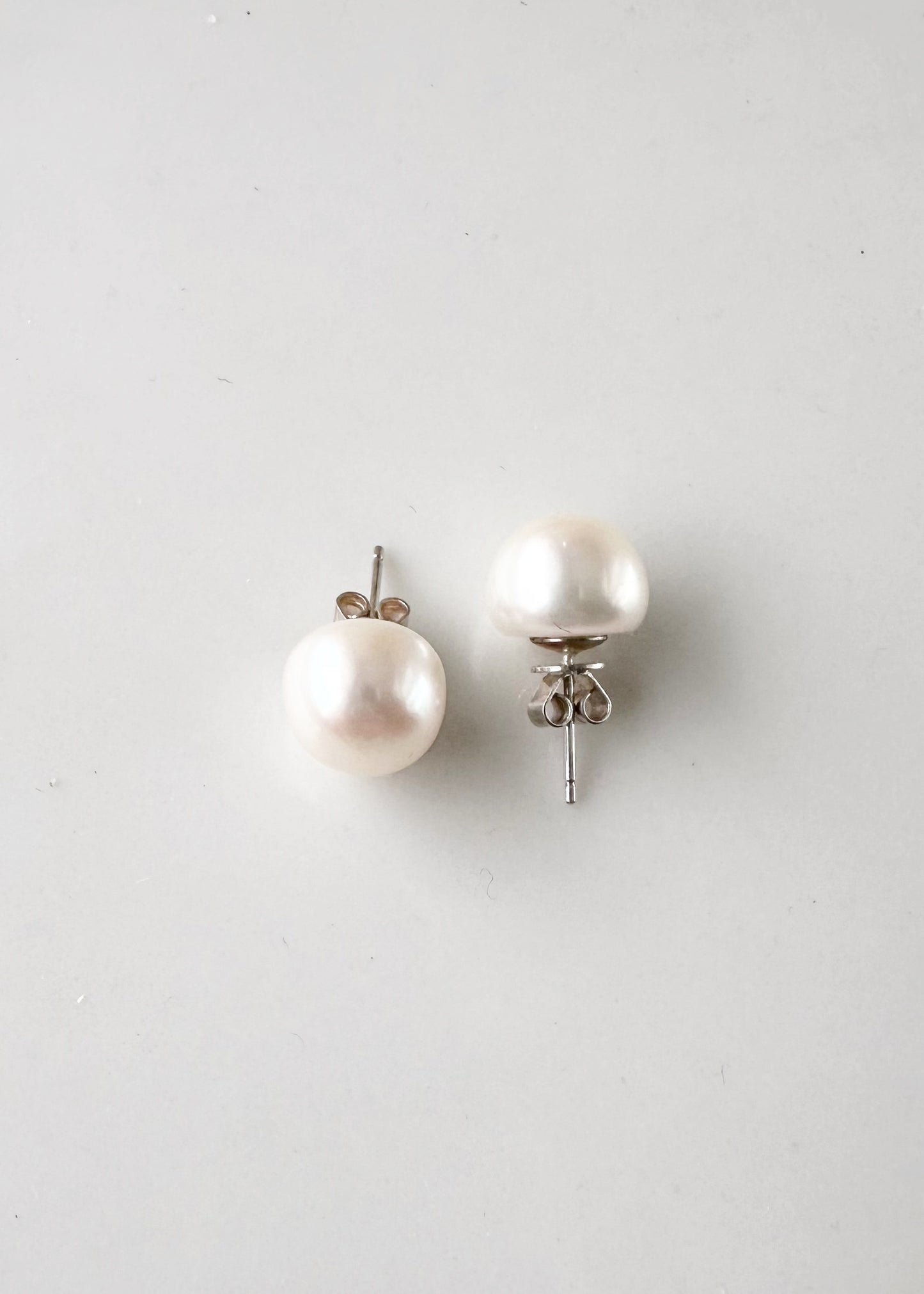 These Pretty White (Grade A) 10-11mm Freshwater Pearl Stud Earrings are on Sterling Silver Post and Butterfly.  A Fan Favorite!