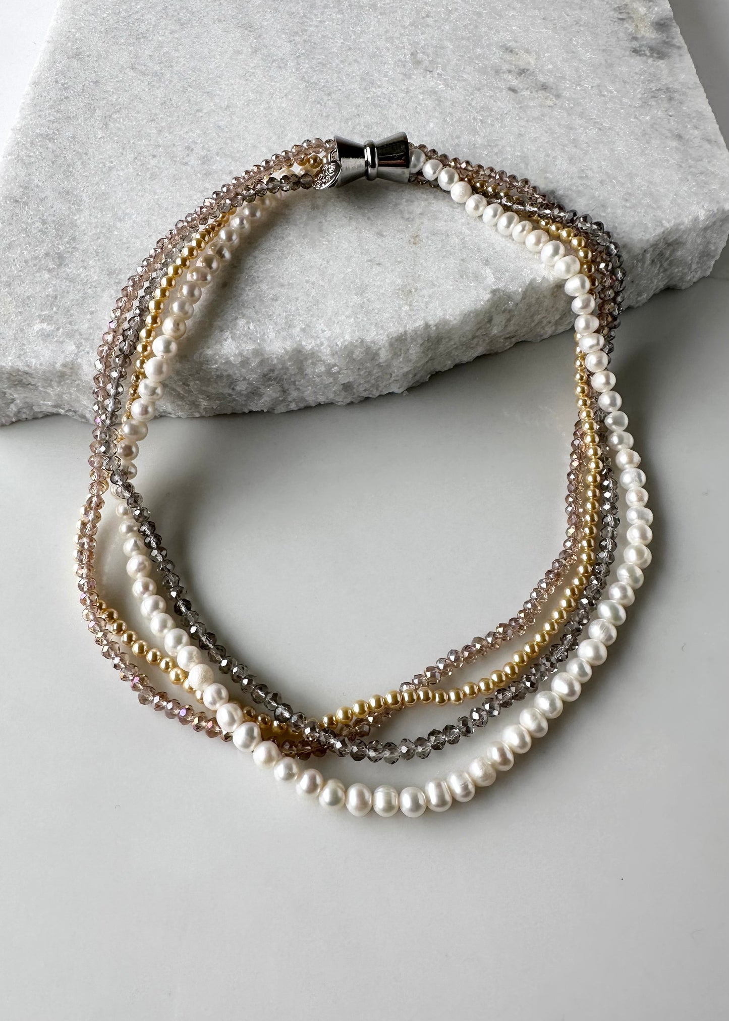 Four Strand 18” Necklace with Pearl, Shell Pearl and Two Tones of Faceted Crystal Completed with Strong secure Magnetic Clasp for Easy Wear.  Wear it Draped or Twisted for Variety.