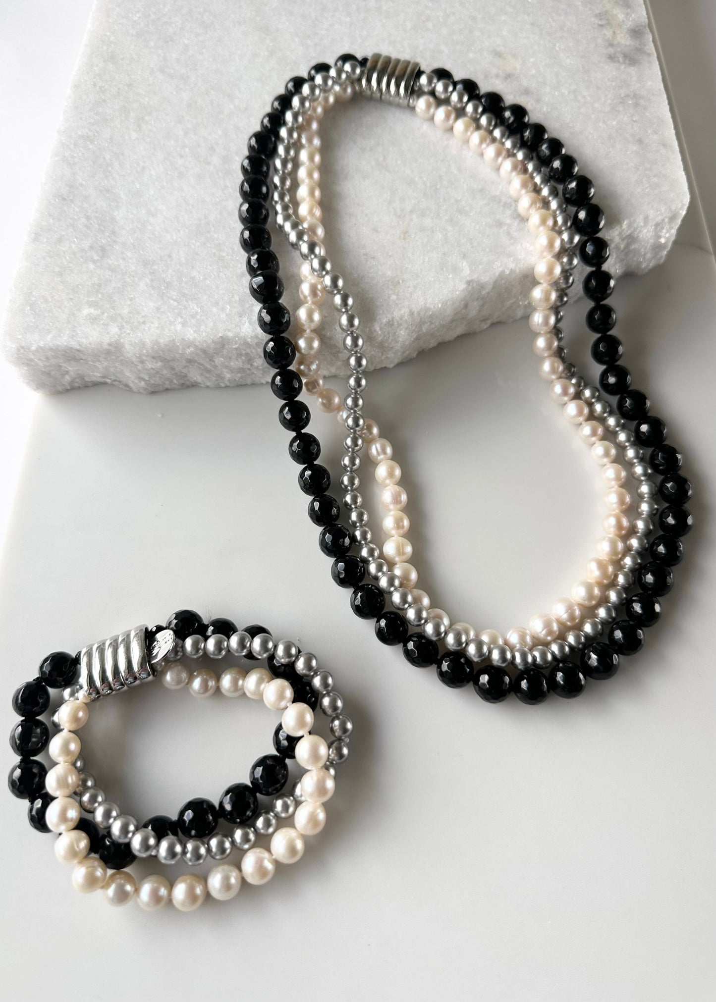 Three Strand Bracelet with White Freshwater Pearls, Black Faceted Agate and Silver Shell Pearls Finished with a Magnetic Clasp for Easy Wear. With Matching Necklace