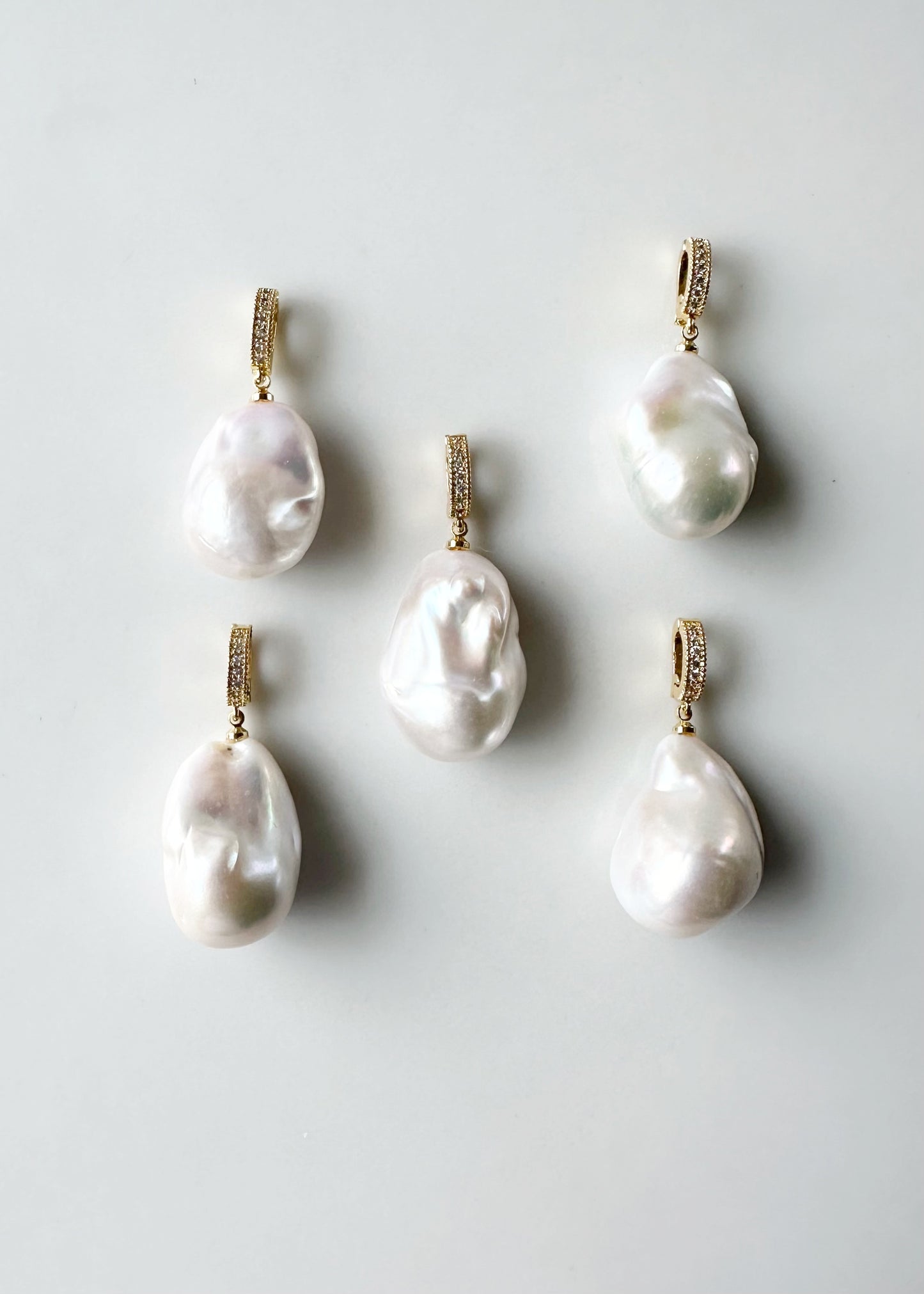 Five Large Baroque White Freshwater Pearl Pendants on Gold-Plated Bail with In-Laid Cubic Zirconia.  This Clip-On Pendant allows you to wear it with many of your favorite Pearl Necklaces.  Each Baroque Pearl has its own unique Beauty!