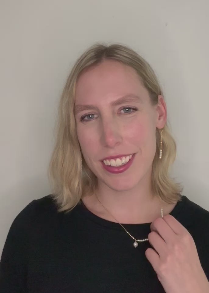 Stack of Five 3mm Freshwater Pearls On Delicate Gold-Plated Chain and Hooks in 2.5” Earring. On Model