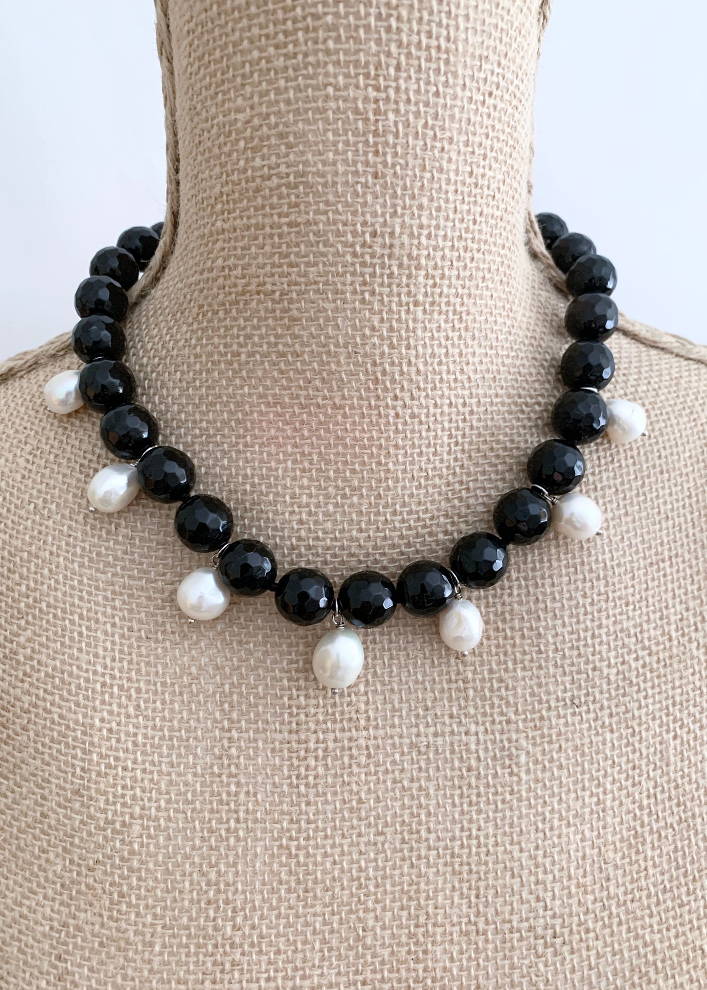 Necklace of Large Black Faceted Agate with seven White Freshwater Drop Pearls.  Strong Secure Magnetic Clasp makes for Easy Wear.  Shown on Bust