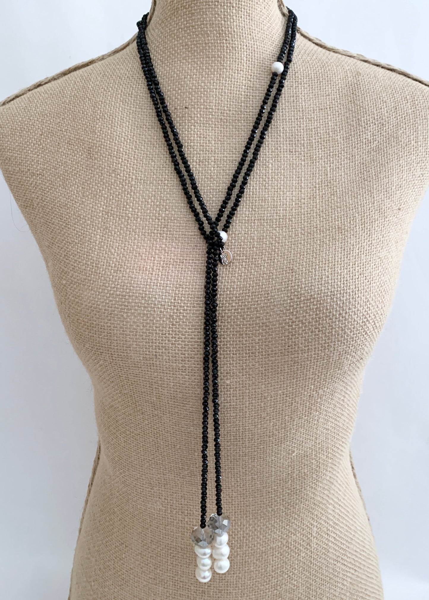 Long, 64-inch Lariat-Style Necklace with Black Crystals and White Freshwater Pearls.  This Versatile piece allows it to be worn in many ways. Shown on Bust