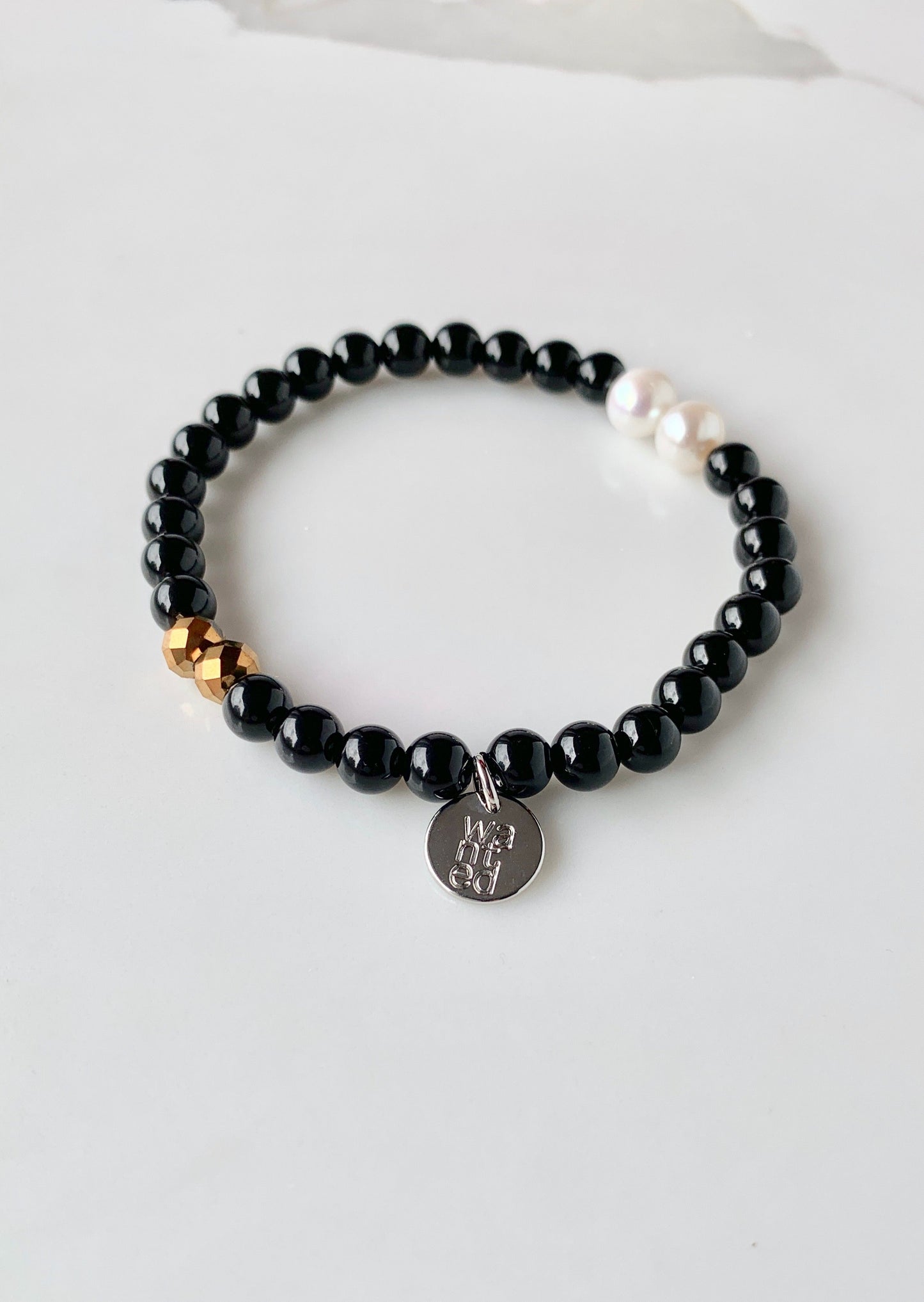 This Stackable Stretch Bracelet is designed with two pearls, two crystals and Black Agate Semi-Precious Stones.  This can be worn by itself or with Gail and Ava Bracelets.