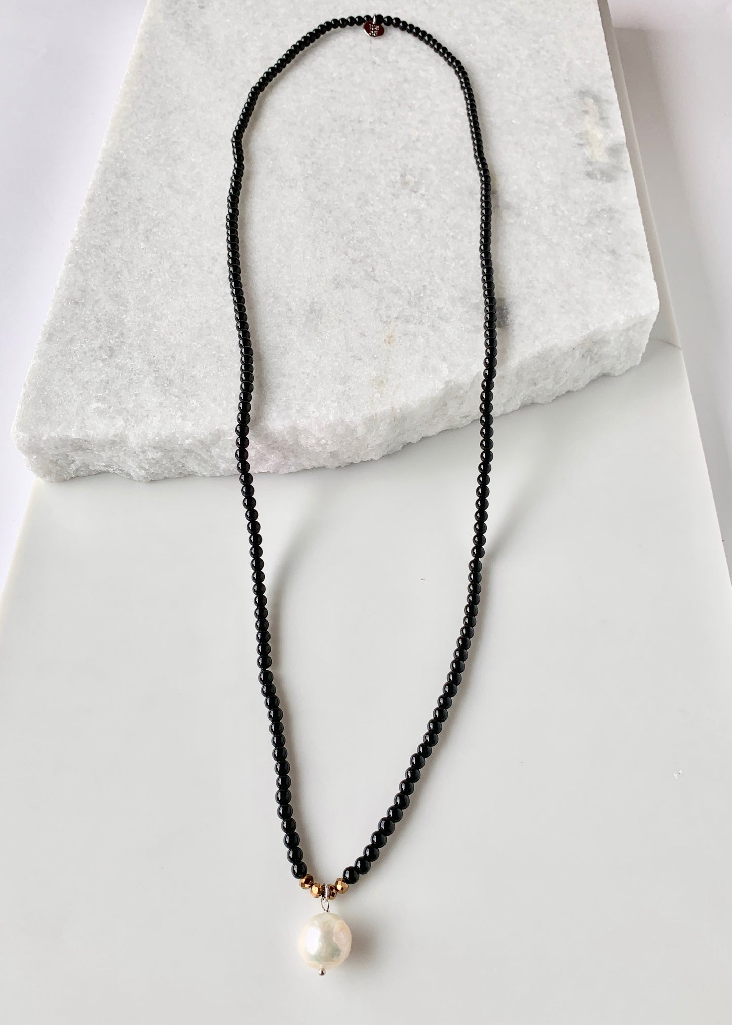 Simple and Elegant, a Large Freshwater Pearl Drop on this Black Agate Necklace with Gold Accents. Can be worn on its own or Stacked with other Necklaces,