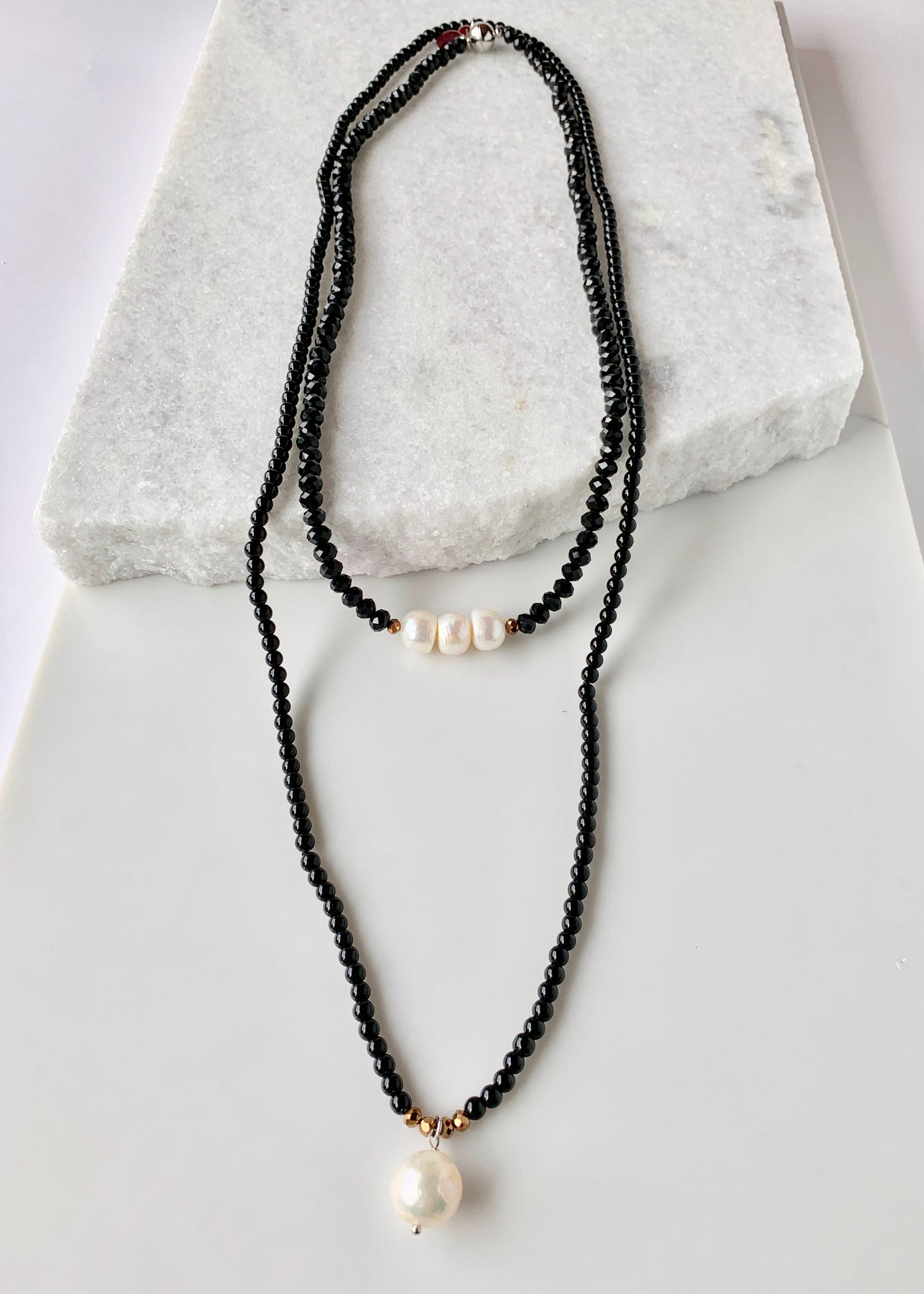 Simple and Elegant, a Large Freshwater Pearl Drop on this Black Agate Necklace with Gold Accents. Can be worn on its own or Stacked with other Necklaces. Layered with a Complementary Necklace.