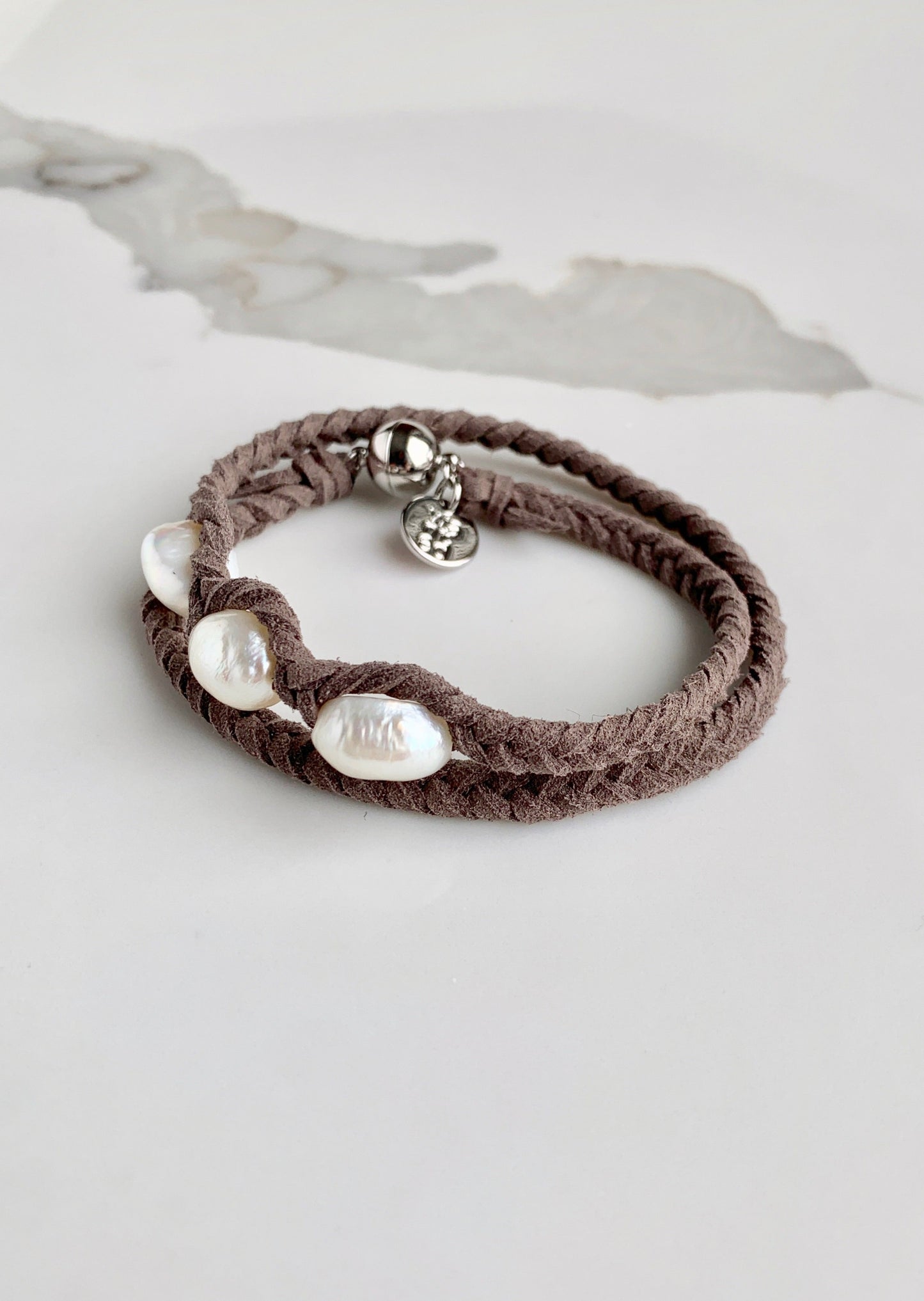 Double Rapped Grey Vegan Suede Bracelet with Three White Baroque Freshwater Pearls on a Strong Secure Magnetic Clasp for Easy Wear.