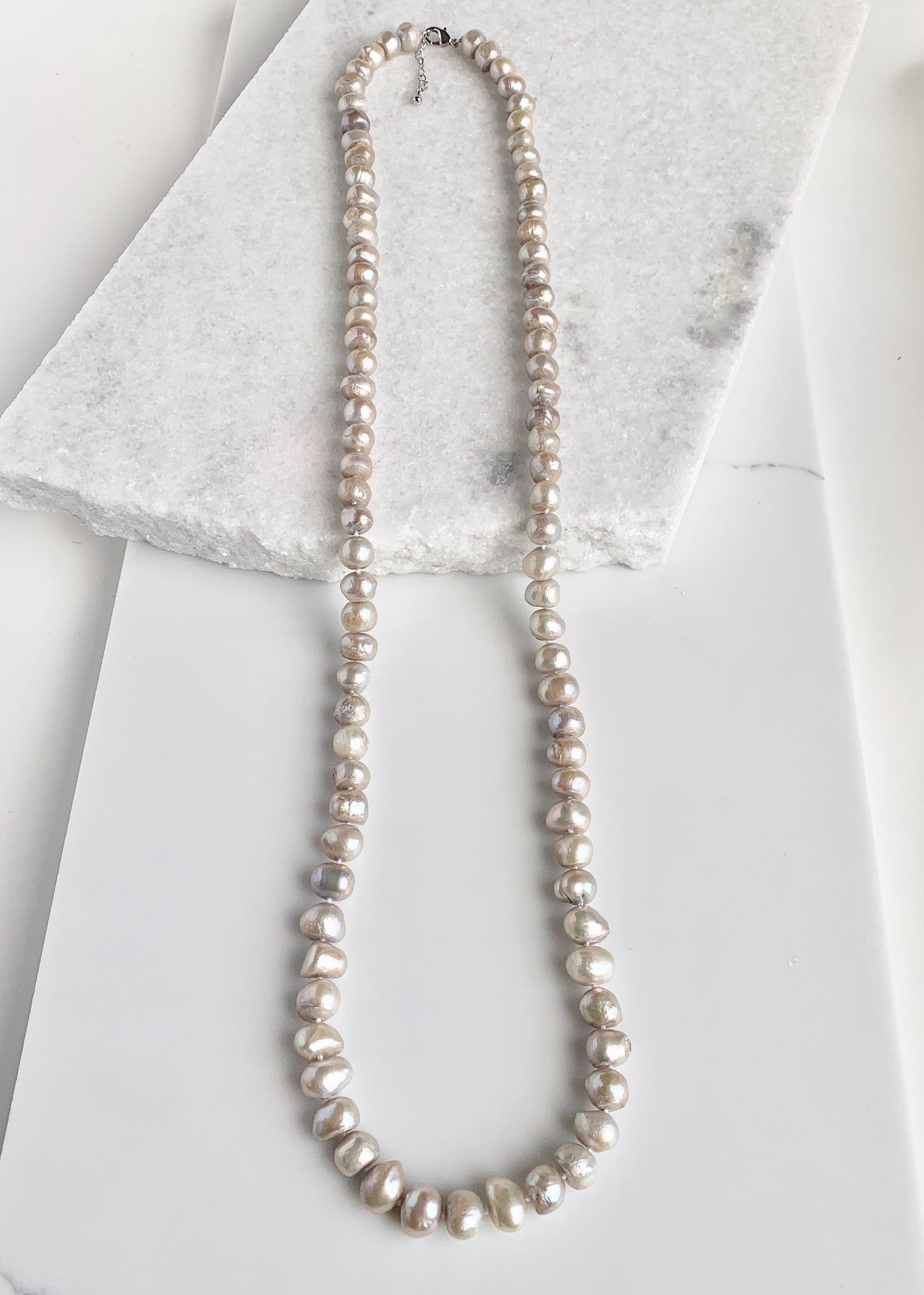 Large (12mm) Lustrous Champagne Freshwater Pearls Knotted on a Long (36”) Necklace that allows for Single or Doubling Up. It is Completed with a Lobster Claw Clasp for Easy, Reliable Wear.