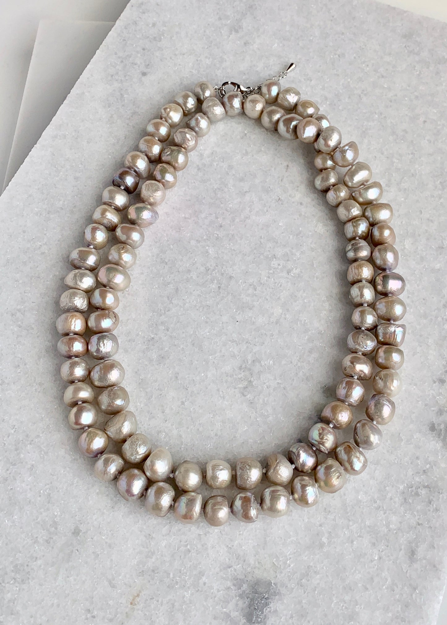 Large (12mm) Lustrous Champagne Freshwater Pearls Knotted on a Long (36”) Necklace that allows for Single or Doubling Up. It is Completed with a Lobster Claw Clasp for Easy, Reliable Wear. Doubled
