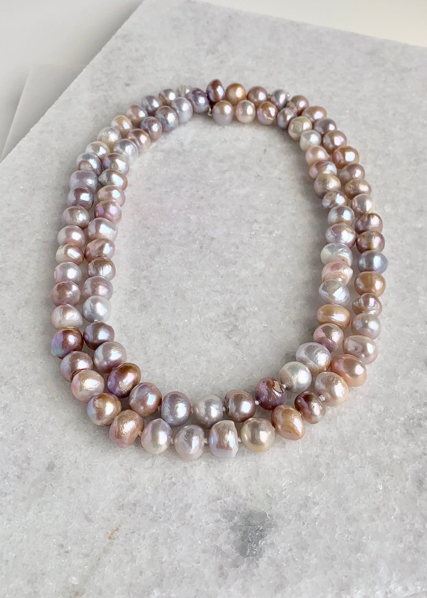 Large (12mm) Lustrous Natural Pink Freshwater Pearls Knotted on a Long (36”) Necklace that allows for Single or Doubling Up. It is Completed with a Lobster Claw Clasp for Easy, Reliable Wear. Doubled