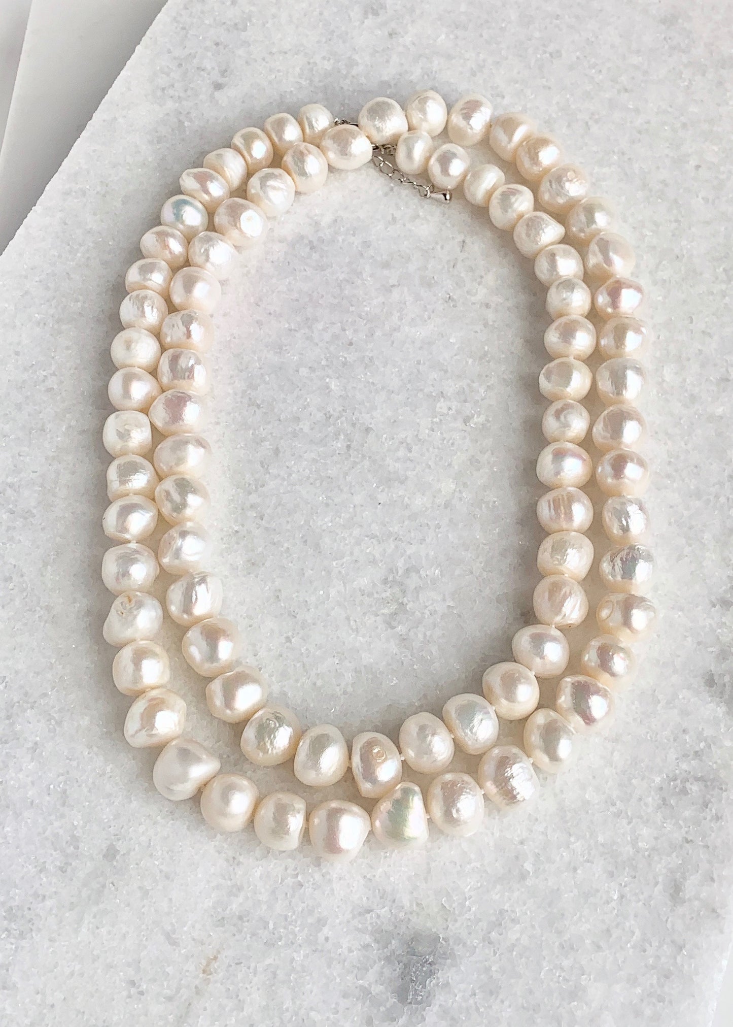 Large (12mm) Lustrous White Freshwater Pearls Knotted on a Long (36”) Necklace that allows for Single or Doubling Up. It is Completed with a Lobster Claw Clasp for Easy, Reliable Wear. Doubled