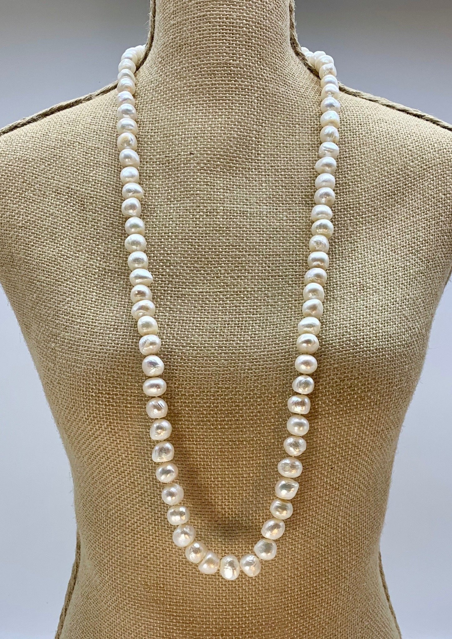 Large (12mm) Lustrous White Freshwater Pearls Knotted on a Long (36”) Necklace that allows for Single or Doubling Up. It is Completed with a Lobster Claw Clasp for Easy, Reliable Wear. On Bust
