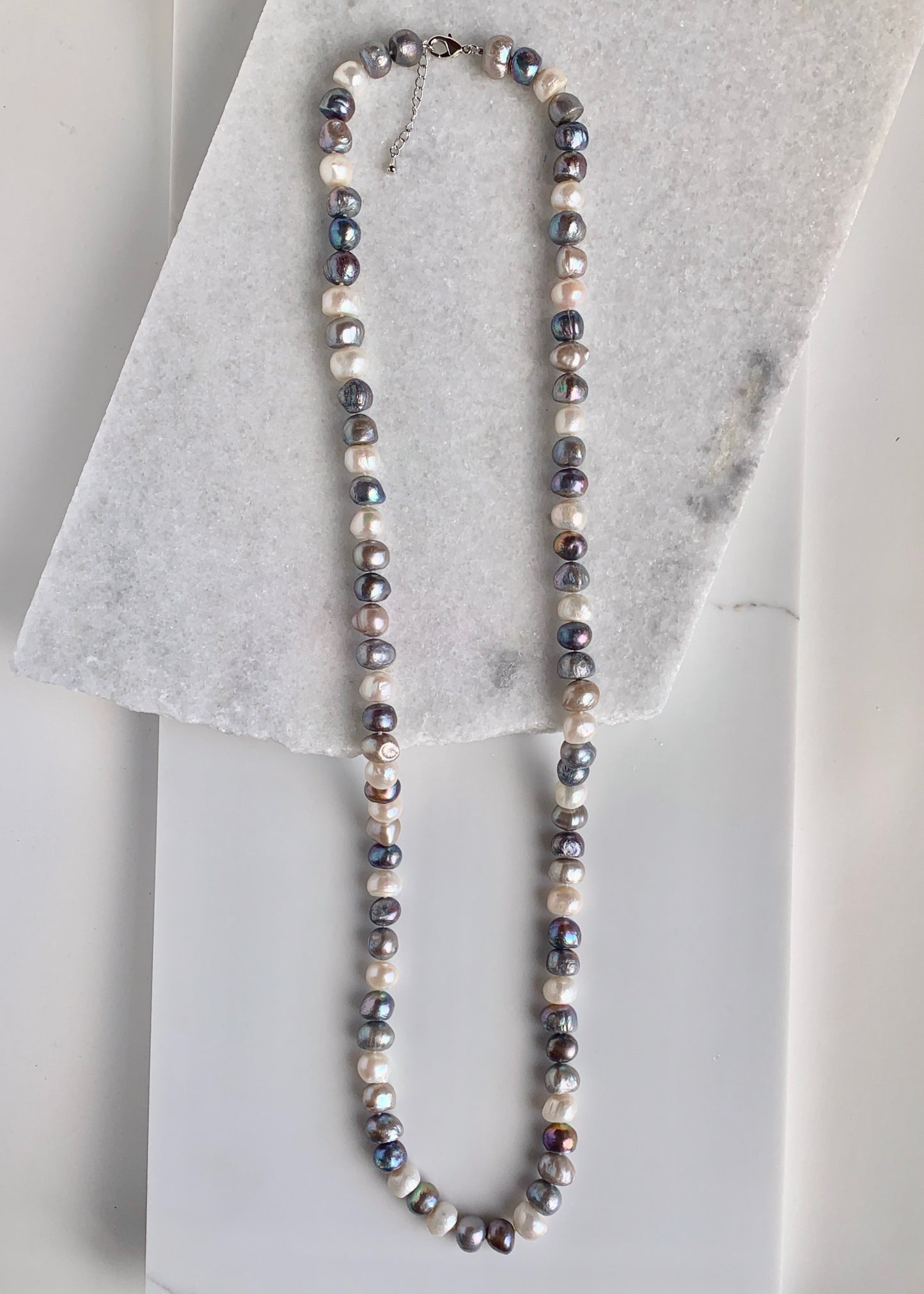 Large (12mm) Lustrous White Silver and Black Freshwater Pearls Knotted on a Long (36”) Necklace that allows for Single or Doubling Up. It is Completed with a Lobster Claw Clasp for Easy, Reliable Wear.