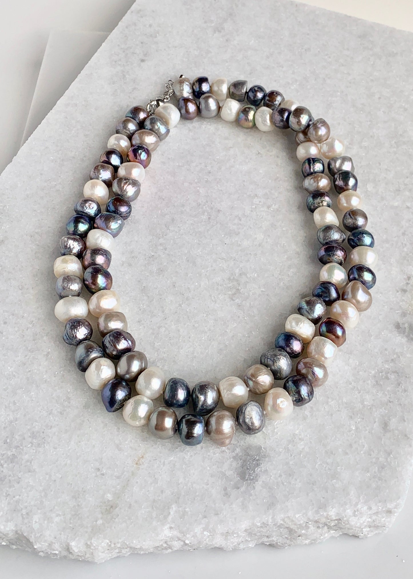 Large (12mm) Lustrous White Silver and Black Freshwater Pearls Knotted on a Long (36”) Necklace that allows for Single or Doubling Up. It is Completed with a Lobster Claw Clasp for Easy, Reliable Wear. Doubled