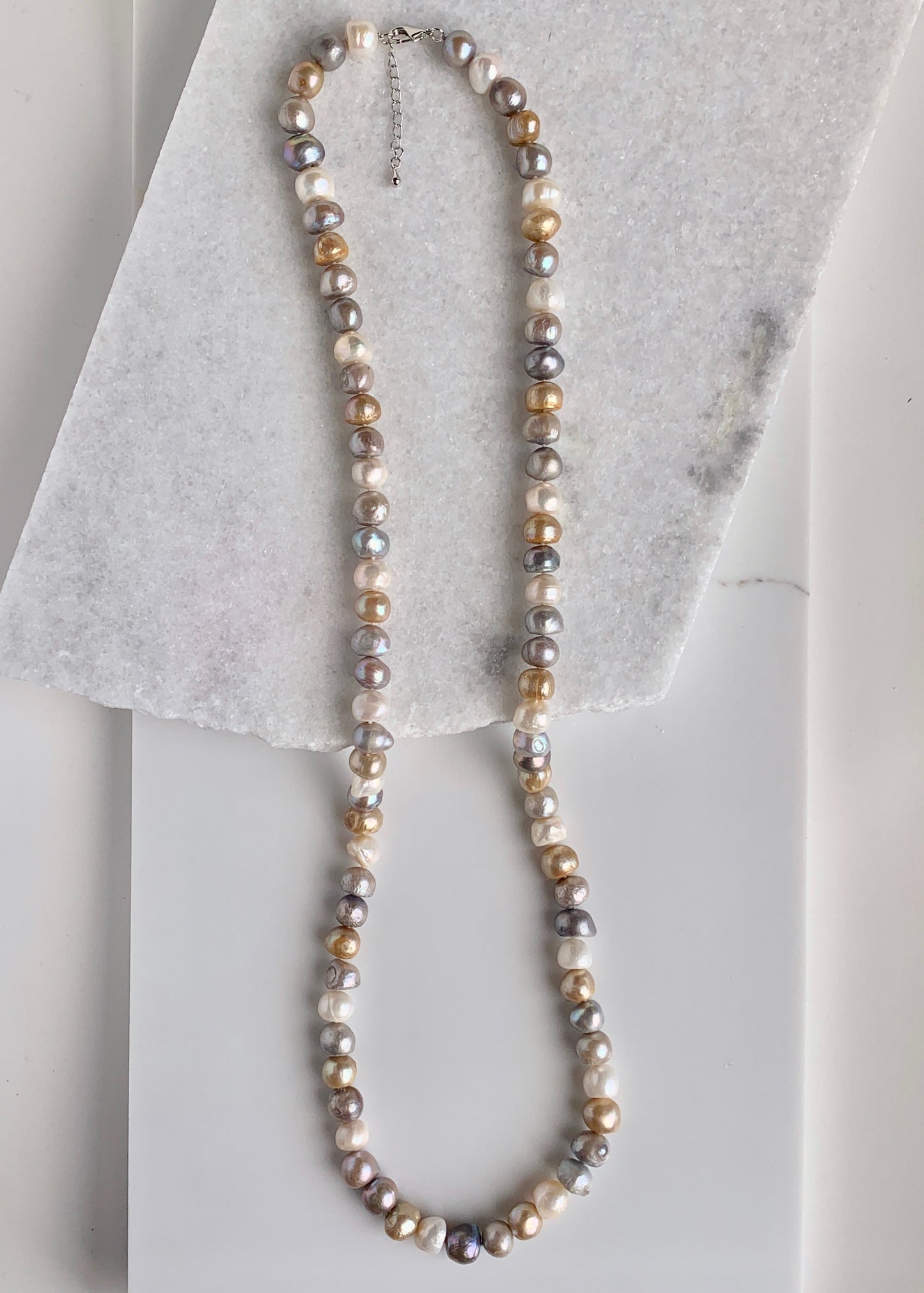 Large (12mm) Lustrous White Silver and Gold Freshwater Pearls Knotted on a Long (36”) Necklace that allows for Single or Doubling Up. It is Completed with a Lobster Claw Clasp for Easy, Reliable Wear.