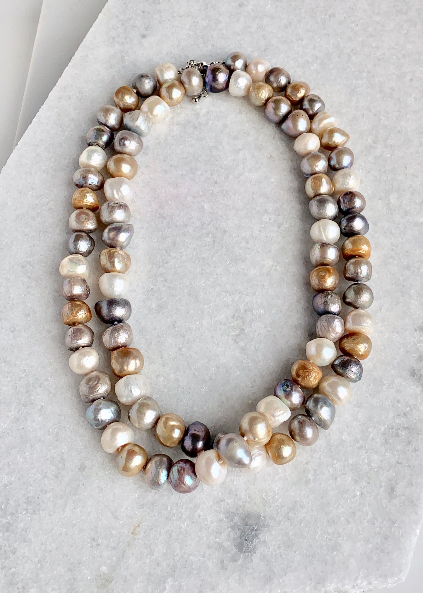 Large (12mm) Lustrous White Silver and Gold Freshwater Pearls Knotted on a Long (36”) Necklace that allows for Single or Doubling Up. It is Completed with a Lobster Claw Clasp for Easy, Reliable Wear. Doubled