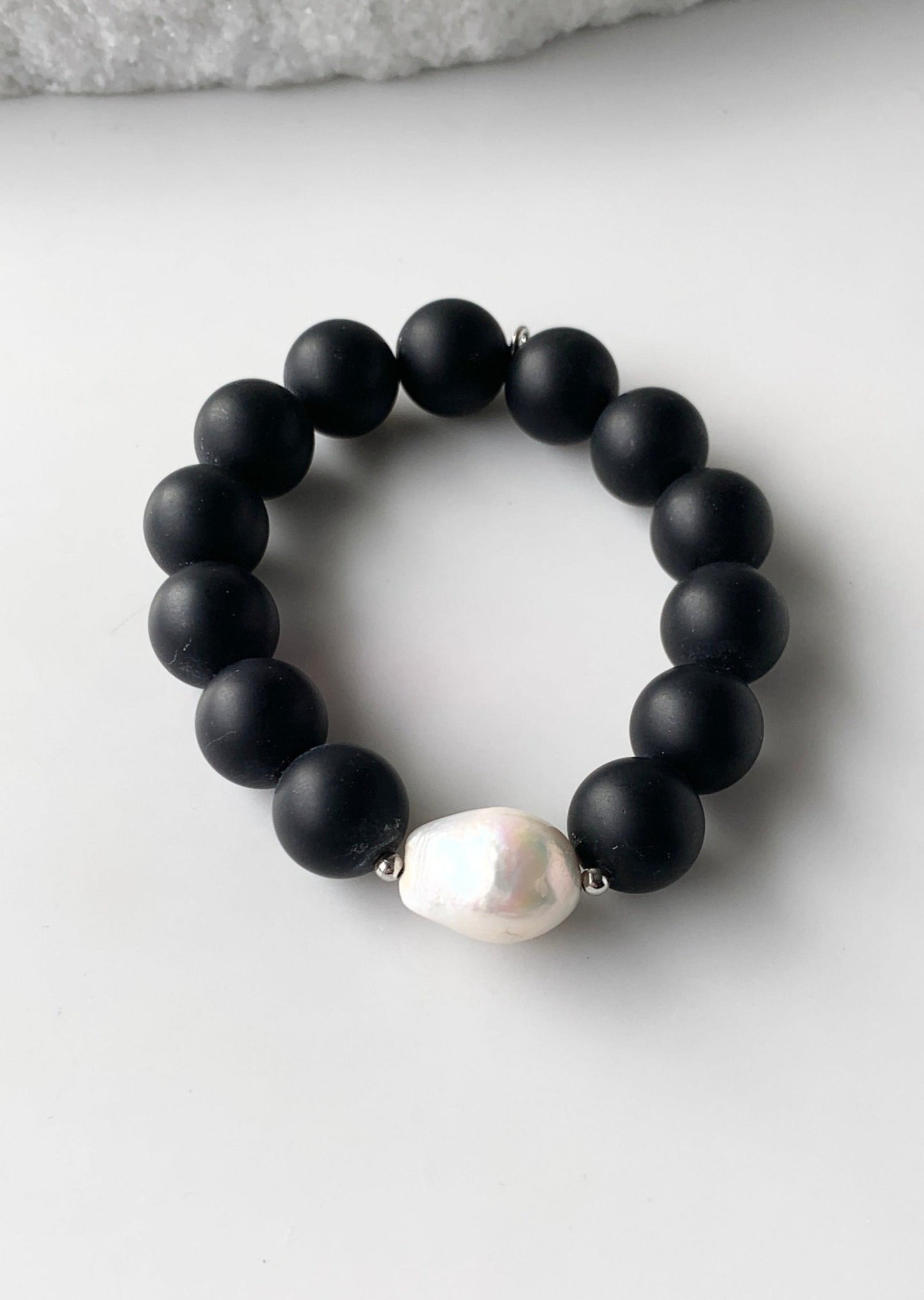 Stretch Bracelet Highlighting a Large White Baroque Freshwater Pearl with Silver Accents with Large (14mm) Matte Black Agate.