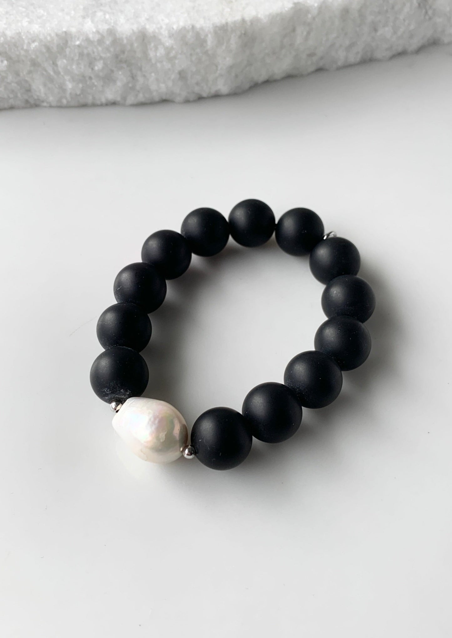 Stretch Bracelet Highlighting a Large White Baroque Freshwater Pearl with Silver Accents with Large (14mm) Matte Black Agate.