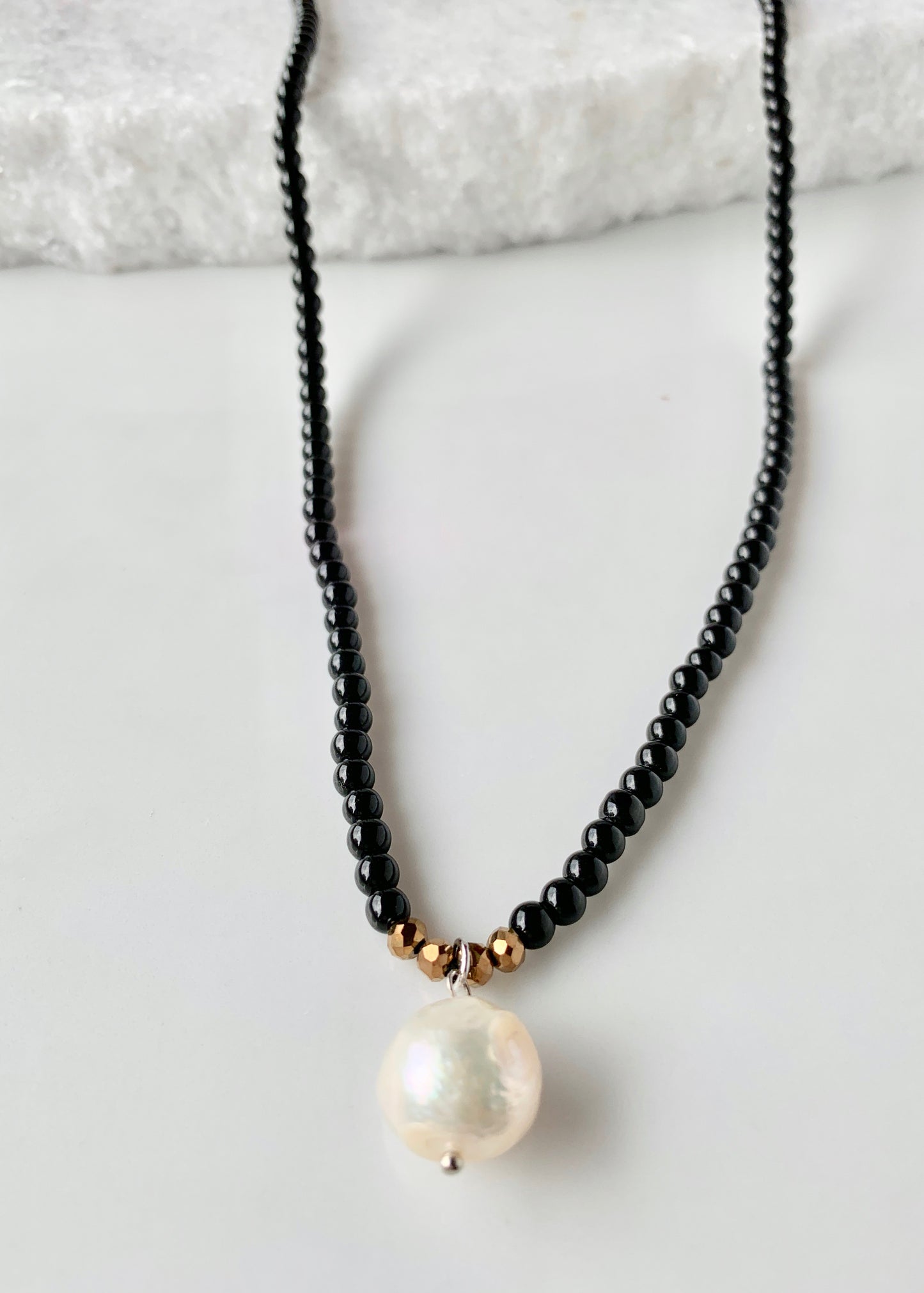 Simple and Elegant, a Large Freshwater Pearl Drop on this Black Agate Necklace with Gold Accents. Can be worn on its own or Stacked with other Necklaces. Drop in Focus