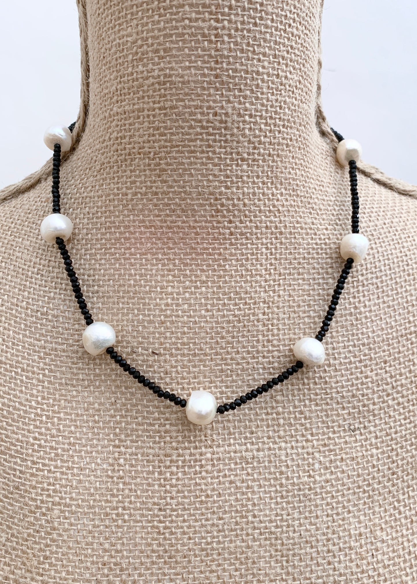 White Freshwater Pearls and Black (2mm) Faceted Crystals form this 18” Necklace with 1.5” Extender.  The Piece is finished with a Lobster Claw Clasp. On Bust