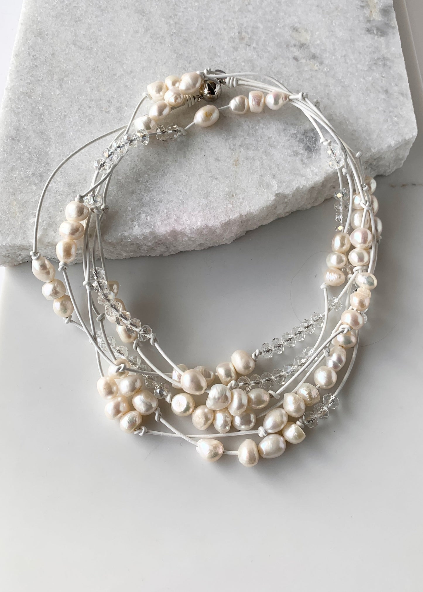 White Baroques Freshwater Pearls and White Faceted Crystals on White Knotted Leather For a Long  39” Necklace with Strong Secure Magnetic Clasp for Easy Wear.