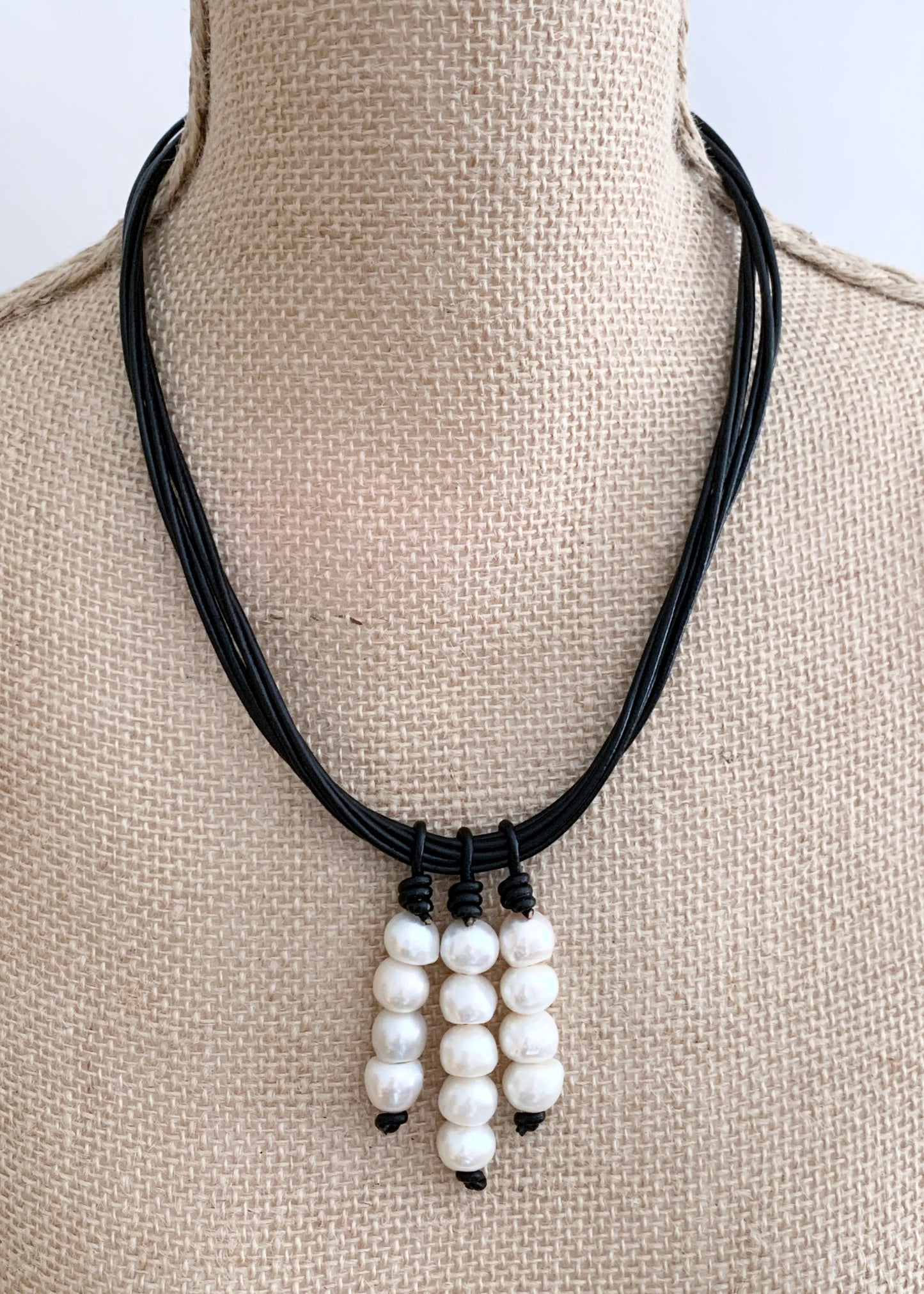 Three Stacks of White Baroque Freshwater Pearls on Black Leather Cord Make Up this Necklace with a Strong Secure Magnetic Clasp for Easy Wear. On Bust