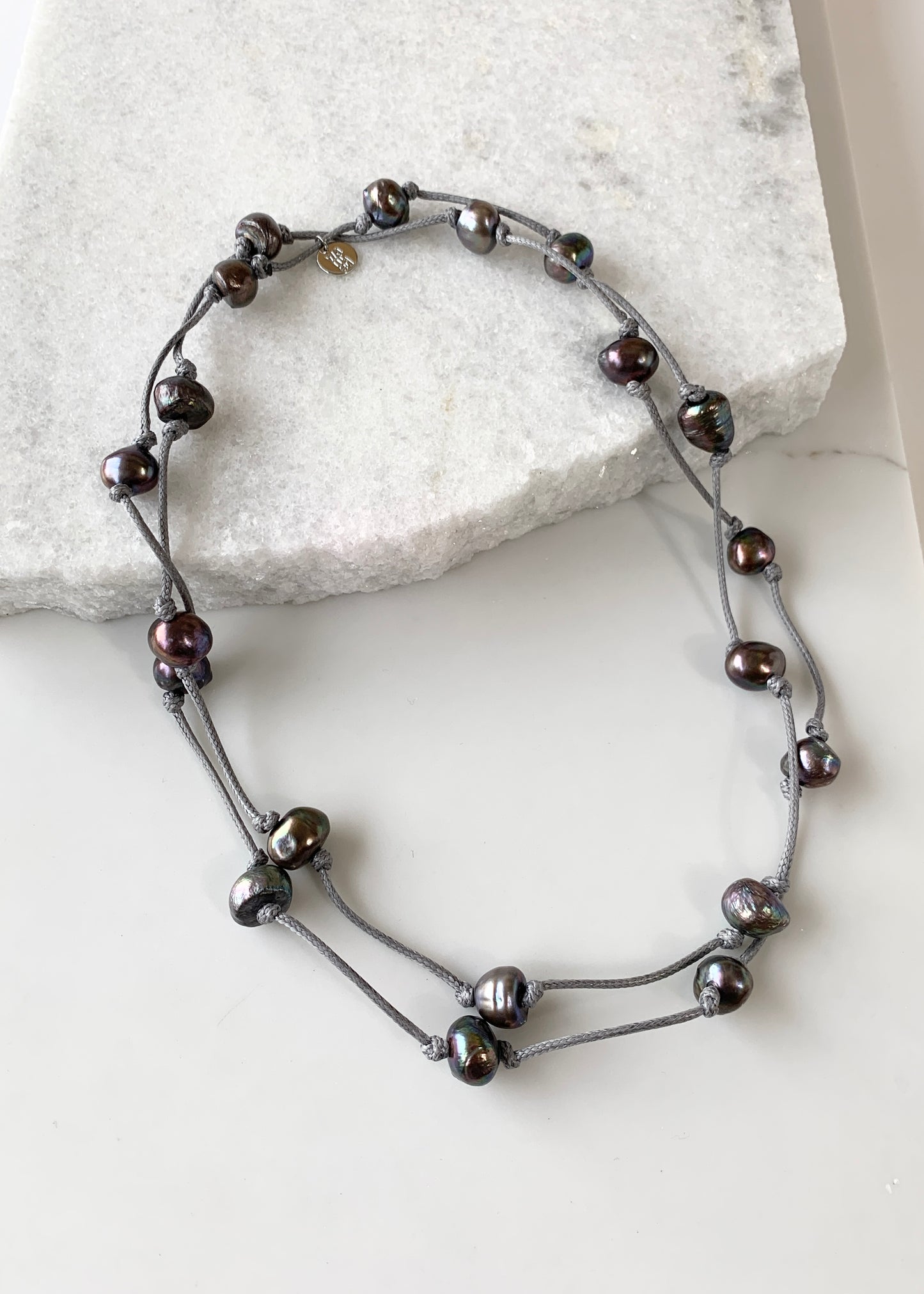 Lustrous Black Freshwater Pearls Knotted on Grey Cotton in this 21” Necklace. Shown Doubled