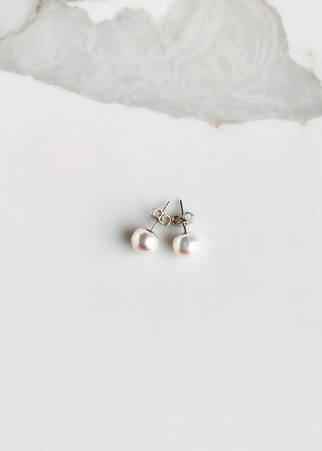 These Pretty White 8mm Freshwater Pearl Stud Earrings are on Sterling Silver Post and Butterfly.  A Fan Favorite!