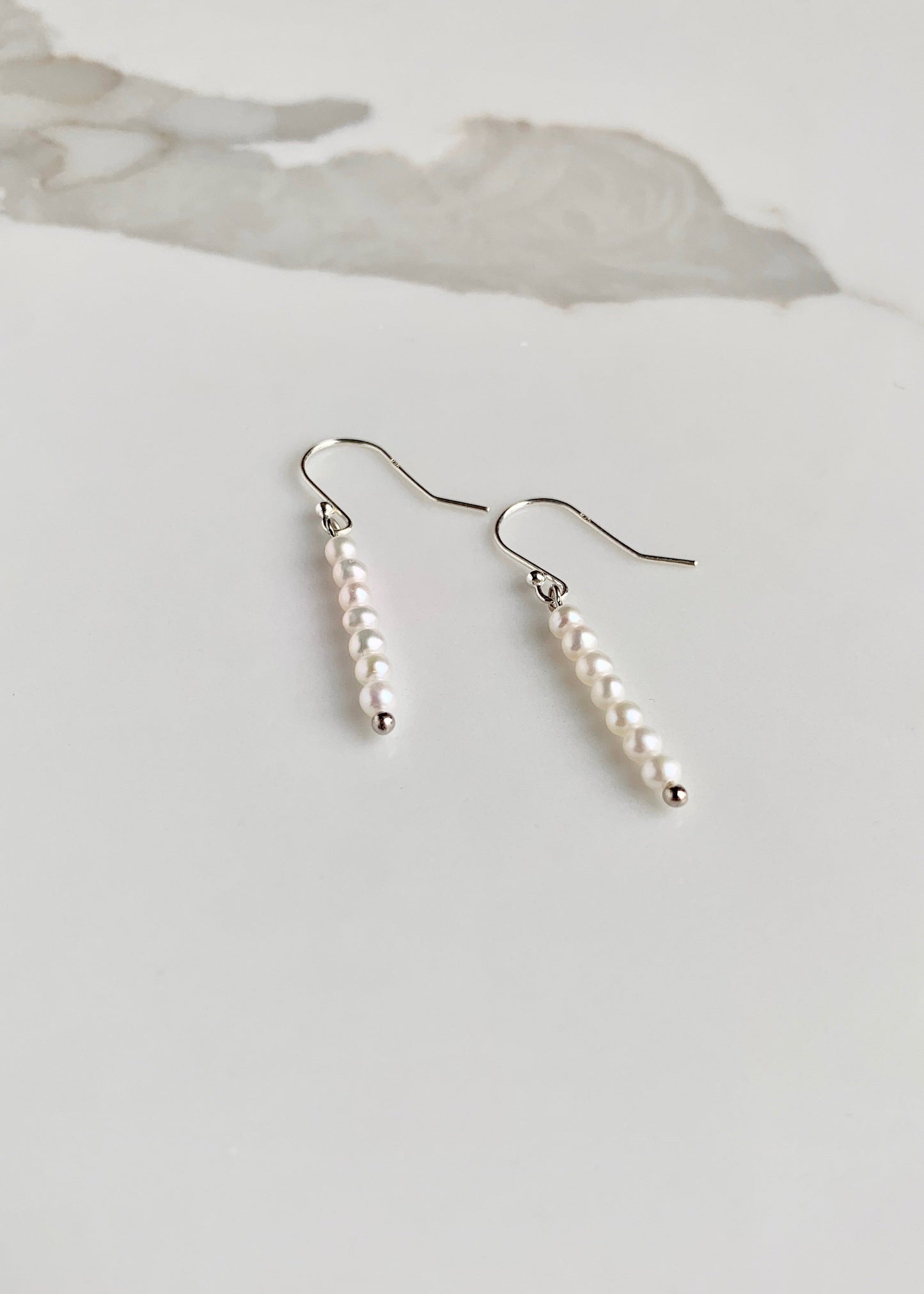 Stack of Seven 3mm White Pearls on Sterling Silver Hooks on this 1.5” Earring.