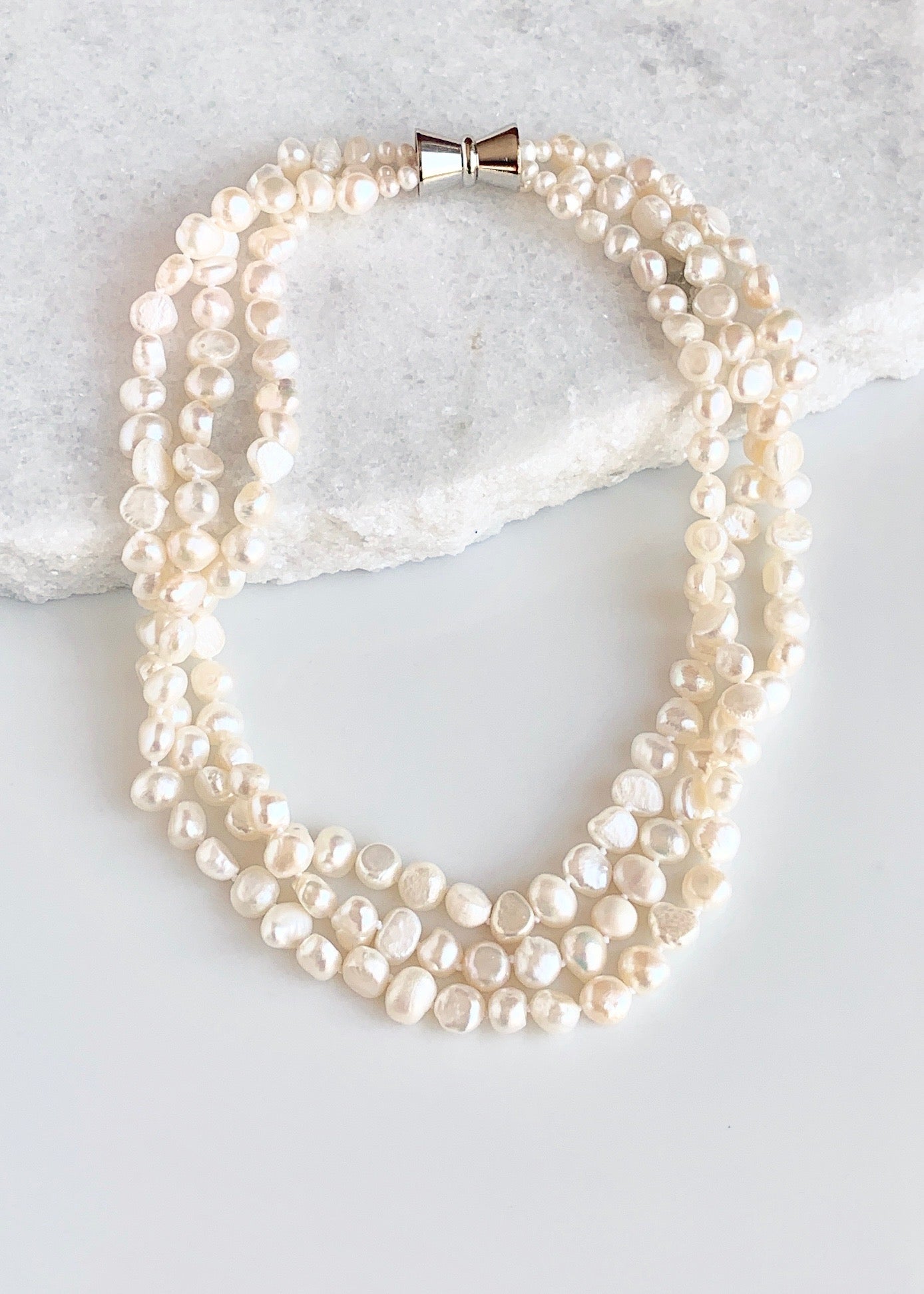 Three Strands of Knotted 8-9mm White Freshwater Baroque Pearls with a Strong Secure Magnetic Clasp for Easy Wear.