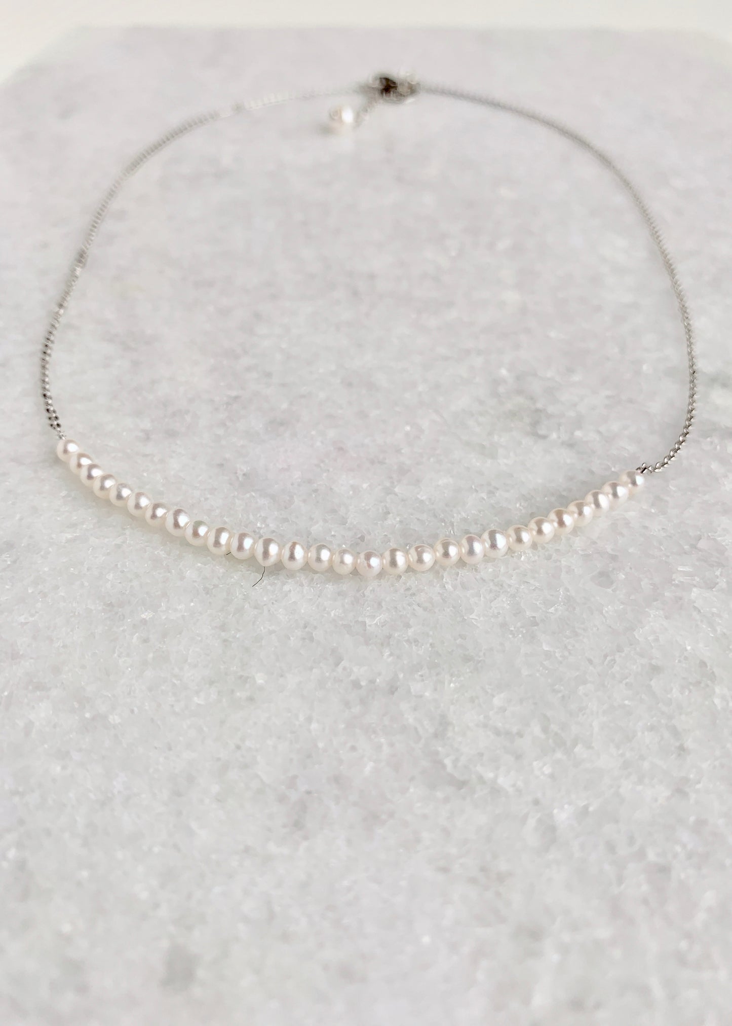 3mm Freshwater White Pearls on White Gold 18” Chain with 1.25” Extender for this Delicate and Classic Necklace which can also be Worn Layered with other Favorites.  Focus on Lustrous Pearls