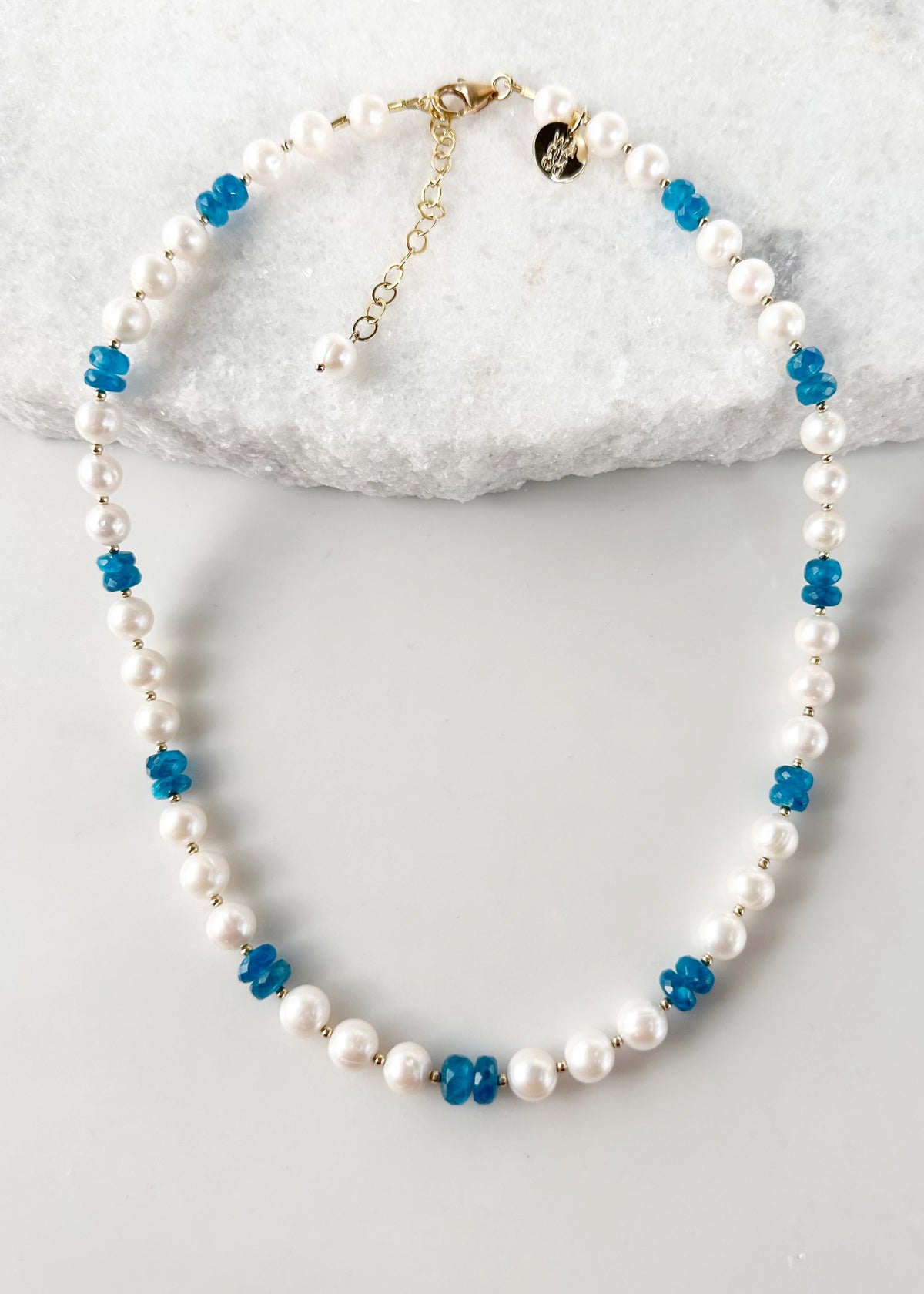 Designed and made in Canada, this one-of-a-kind 18.5” Necklace with 2.5" extender chain features a gorgeous shade of Faceted Blue Apatite(AAA grade) with lustrous white Pearls accented by tiny Gold beads and a Gold-filled Clasp. This Apatite is beautiful!