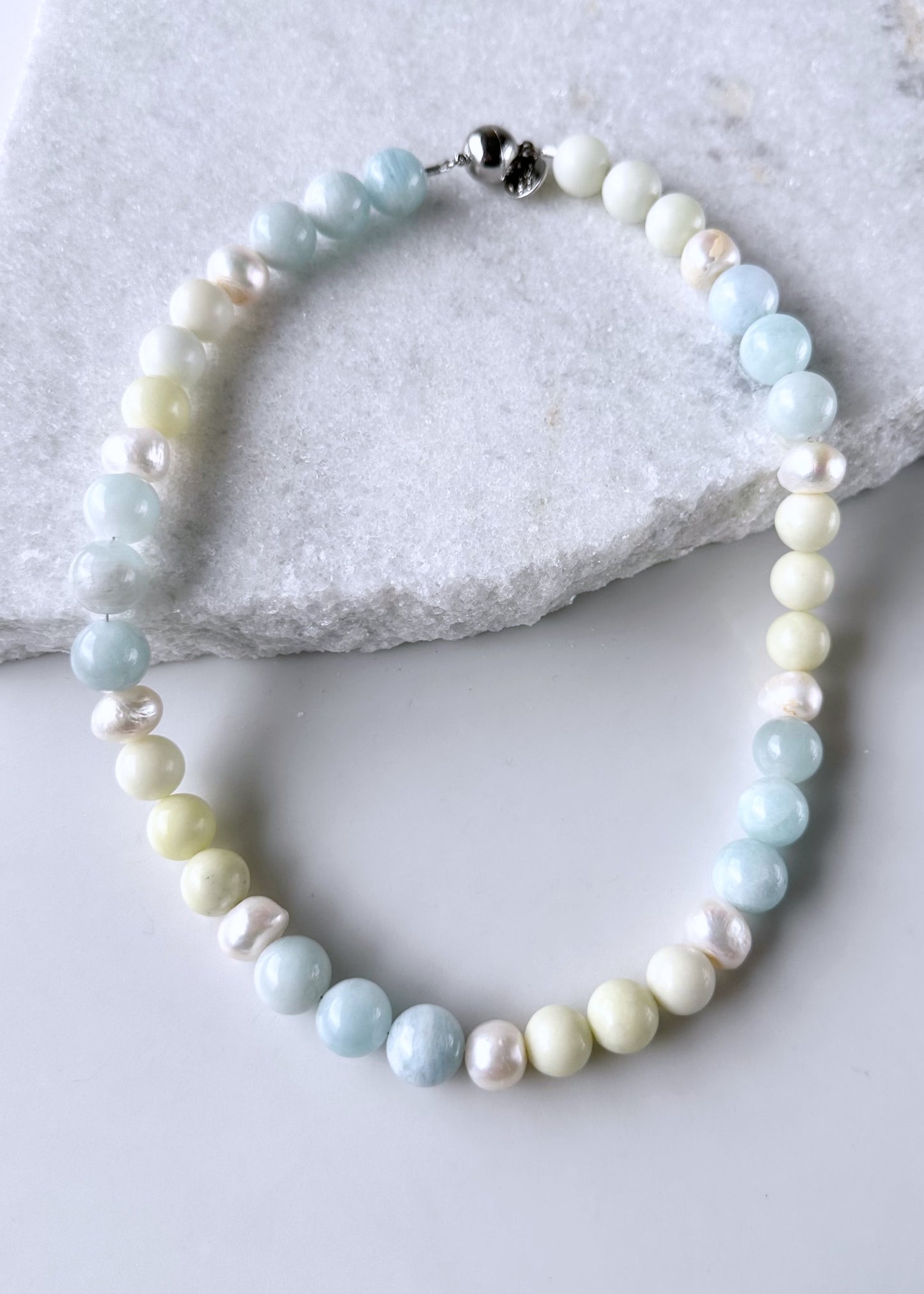 Designed and Made in Canada, this Limited-Edition 20” Necklace combines soothing Blue Aquamarine, Pale Green Jasper, and Luminous Freshwater Pearls into an Effortlessly Elegant Piece. This is perfect for Layering or Wearing Alone. Timeless, versatile, and made to wear well every day with a Simple, Secure Magnetic Clasp.