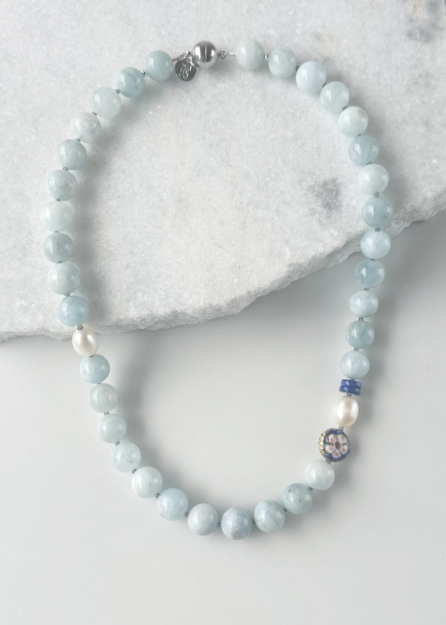 Designed and made in Canada, this Limited Edition Necklace combines Soft Blue Aquamarine, Lapis Rondelles, a Royal Blue Cloisonné Bead and Luminous Freshwater Pearls for an Effortlessly Elegant piece, finished with a Magnetic Clasp. The 22.5