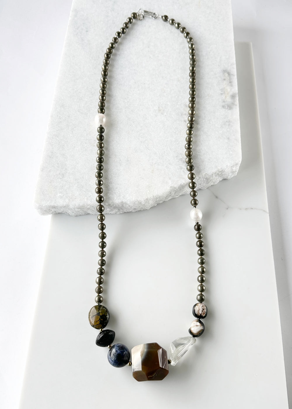 Stunning! This Long (39.5”) Necklace features Large Faceted Agate, Sodalite, Clear Quartz, Pyrite, Brown Turquoise, and Two Edison Pearls, Finished with a Charm Clasp.  This piece can be worn as is or Doubled. 