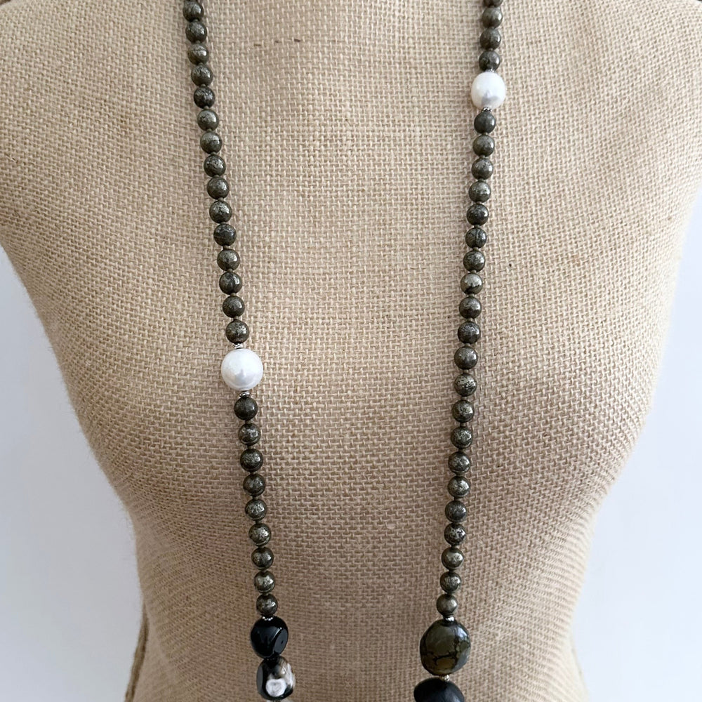 
                      
                        Stunning! This Long (39.5”) Necklace features Large Faceted Agate, Sodalite, Clear Quartz, Pyrite, Brown Turquoise, and Two Edison Pearls, Finished with a Charm Clasp.  This piece can be worn as is or Doubled. 
                      
                    