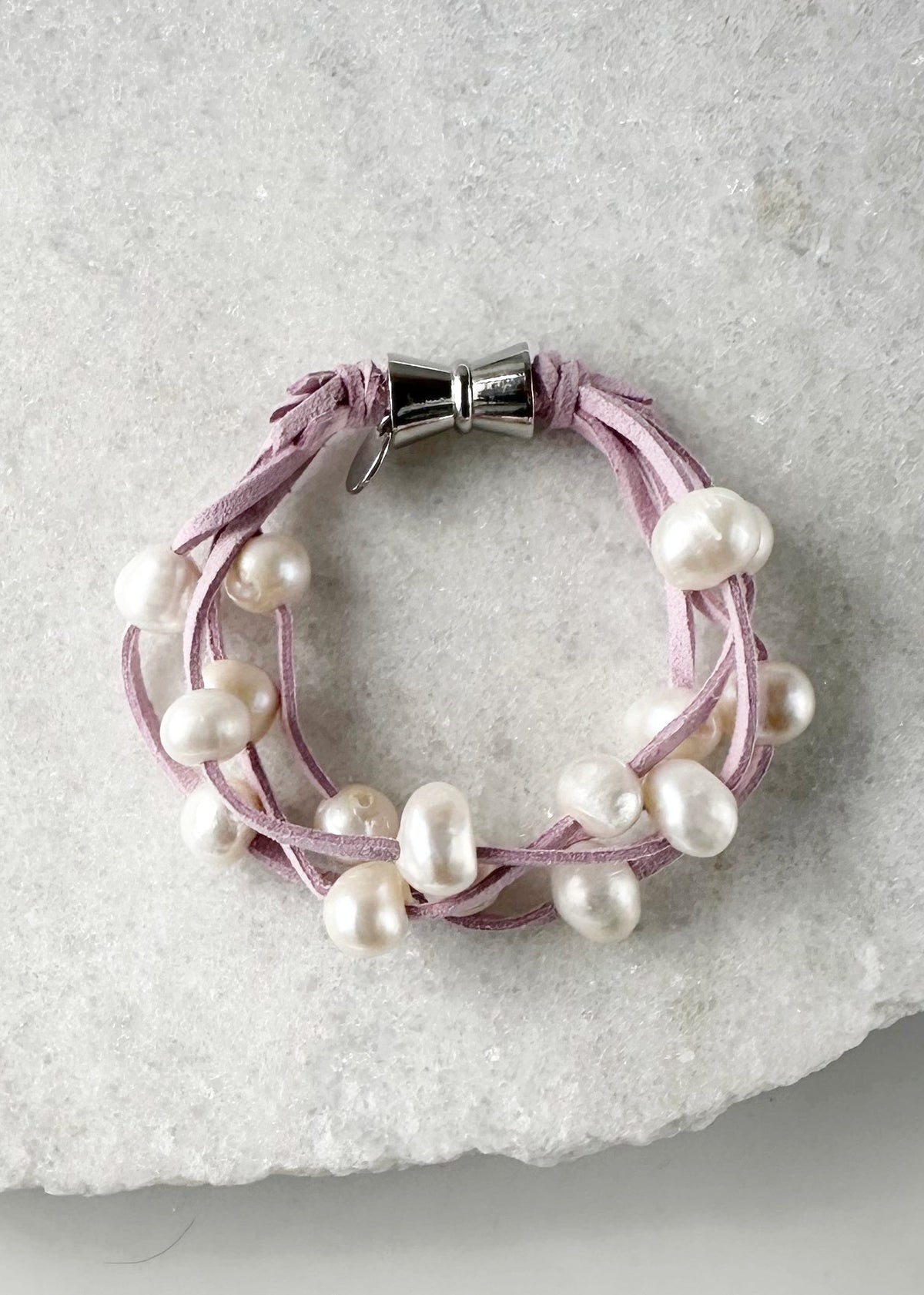 Designed in Canada, the 8” Anna Bracelet has 4 strands of Large, Organic Pearls Floating on Pink or Green Vegan Suede. Easy to take on/off with a Secure Magnetic Clasp.