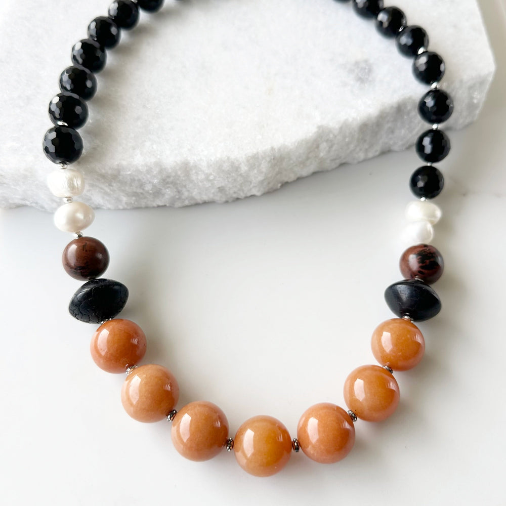 This One-Of-A-Kind 22.5” Necklace Features Large, Round, Orange Aventurine, Black Agate, Mahogany Obsidian and Pearls, Accented with Silver and Finished with a Sterling Silver Lobster Claw Clasp.