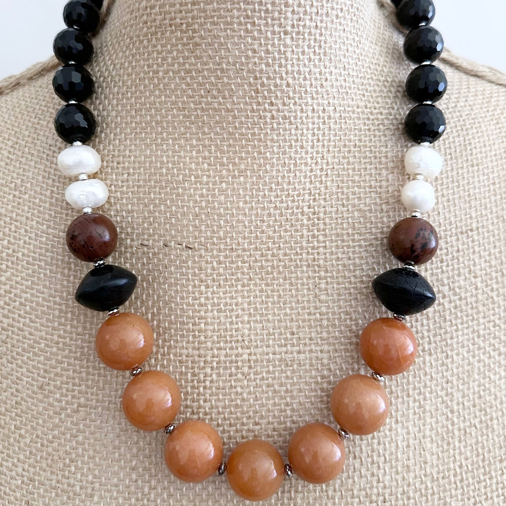 This One-Of-A-Kind 22.5” Necklace Features Large, Round, Orange Aventurine, Black Agate, Mahogany Obsidian and Pearls, Accented with Silver and Finished with a Sterling Silver Lobster Claw Clasp.