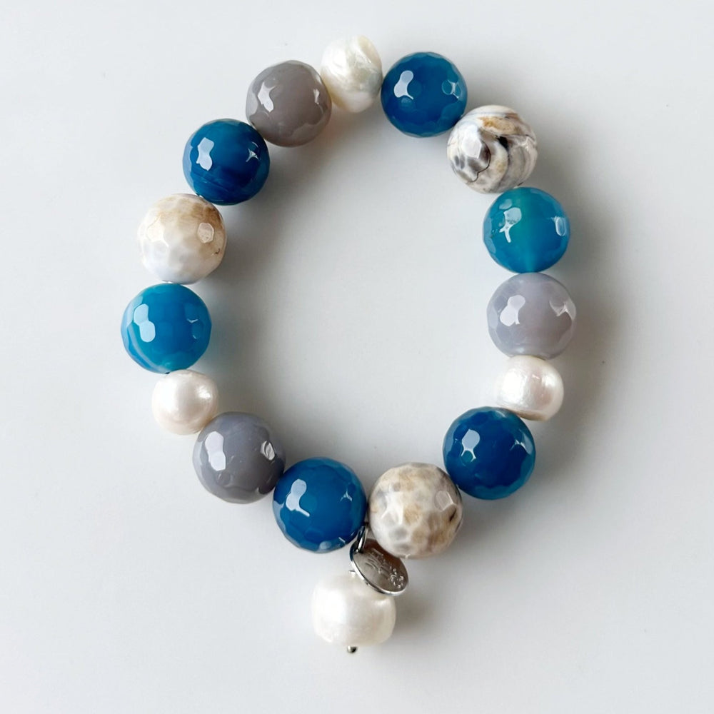 
                      
                        White Freshwater Pearl with Blue Semi-Precious Stone Mix Stretch Bracelet.  Perfect for layering!
                      
                    