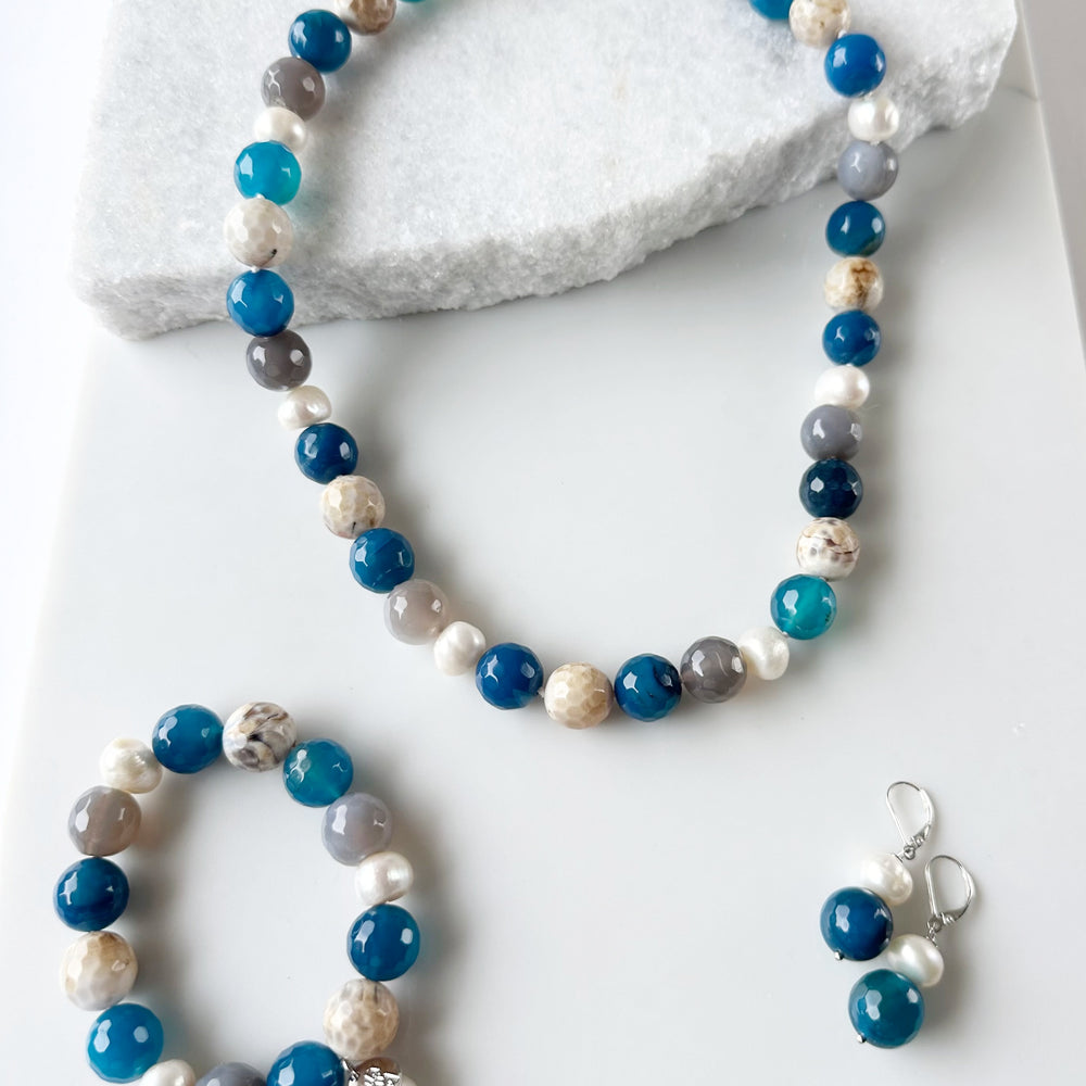 
                      
                        White Freshwater Pearl with Blue Semi-Precious Stone Mix Stretch Bracelet.  Perfect for layering! Shown with Matching Necklace and Earrings
                      
                    