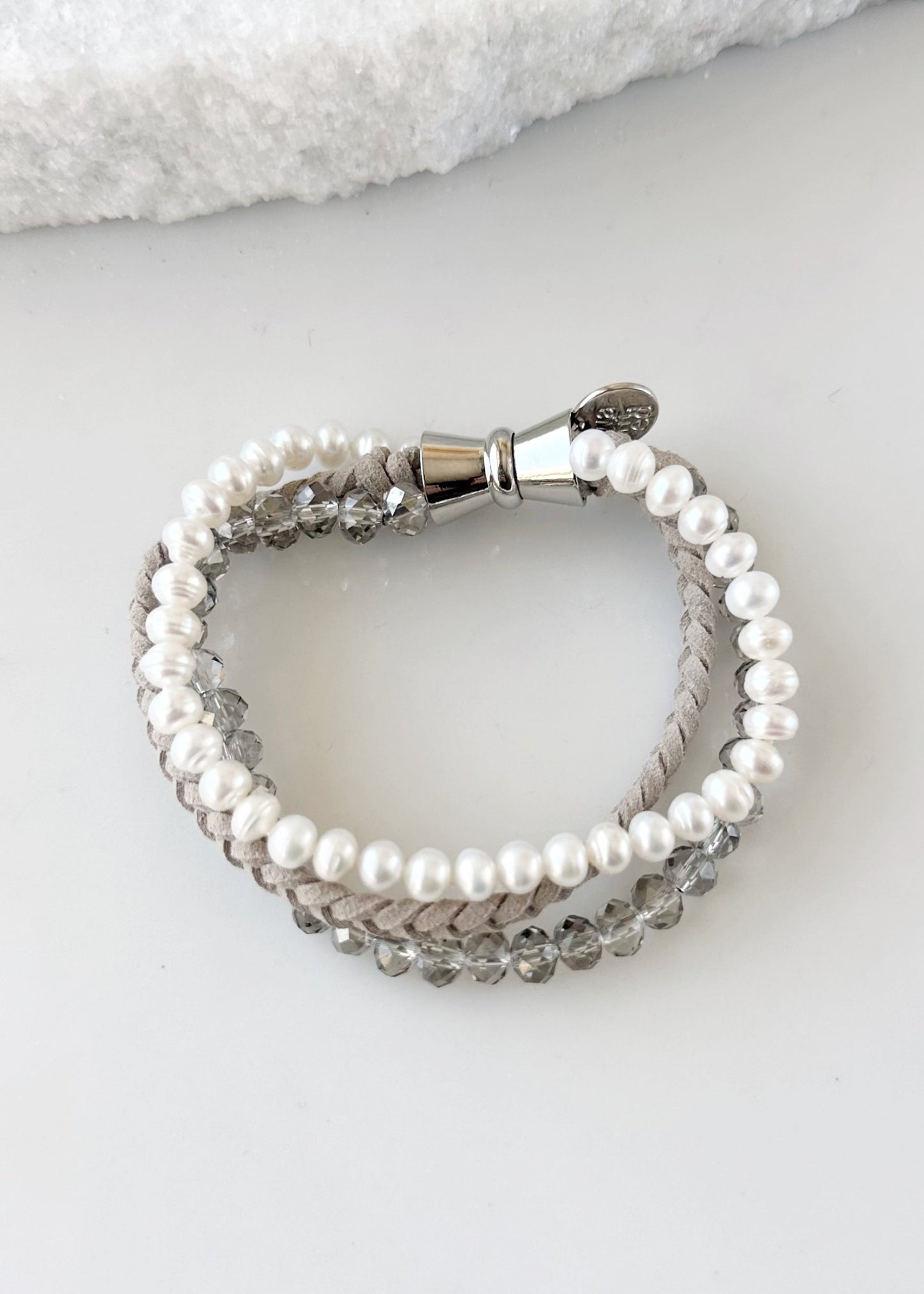 Designed in Canada, the 7.5” Blair Bracelet Features Three Strands of Coordinating Shades of Braided Suede, 6mm Crystal and White Freshwater 6mm Pearls and finished with a Magnetic Clasp for Easy Wear. The Blair Bracelet coordinates with the Carly Necklace and Cora Earring.