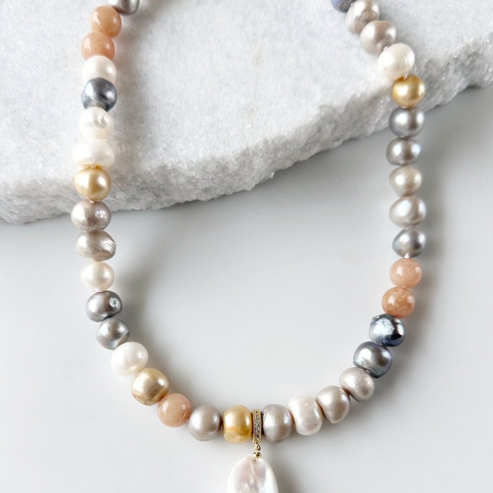 
                      
                        Large Baroque White Freshwater Pearl Pendant on Gold-Plated Bail with In-Laid Cubic Zirconia.  This Clip-On Pendant allows you to wear it with many of your favorite Pearl Necklaces. Here, shown on Mixed  Peach Bianca Pearl Necklace.
                      
                    