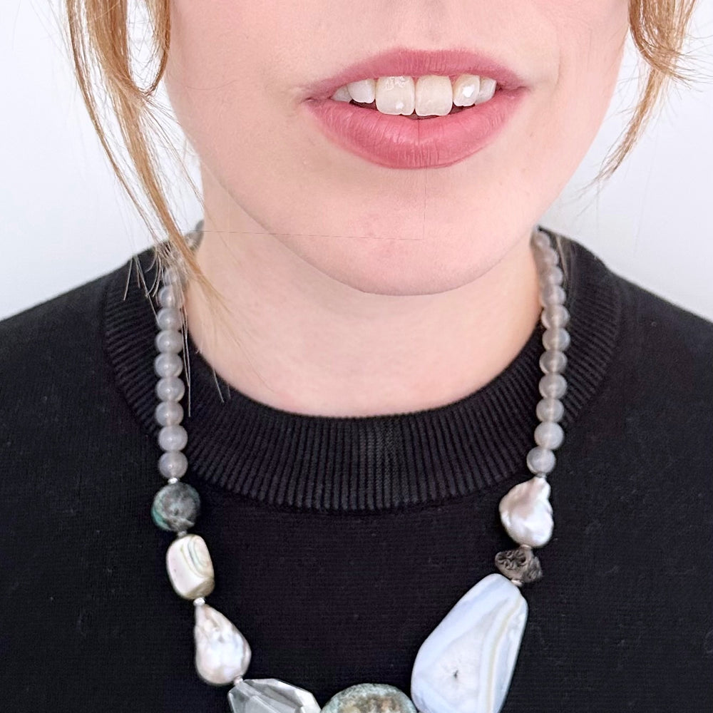 
                      
                        This Unique 20” Necklace Features Blue Lace & Grey Agate, Turquoise, Azurite Chrysocolla, Shell, Crystal, Beautiful Baroque Pearls and Finished with Silver Beads and a Strong Secure Magnetic Clasp for Easy Wear.
                      
                    